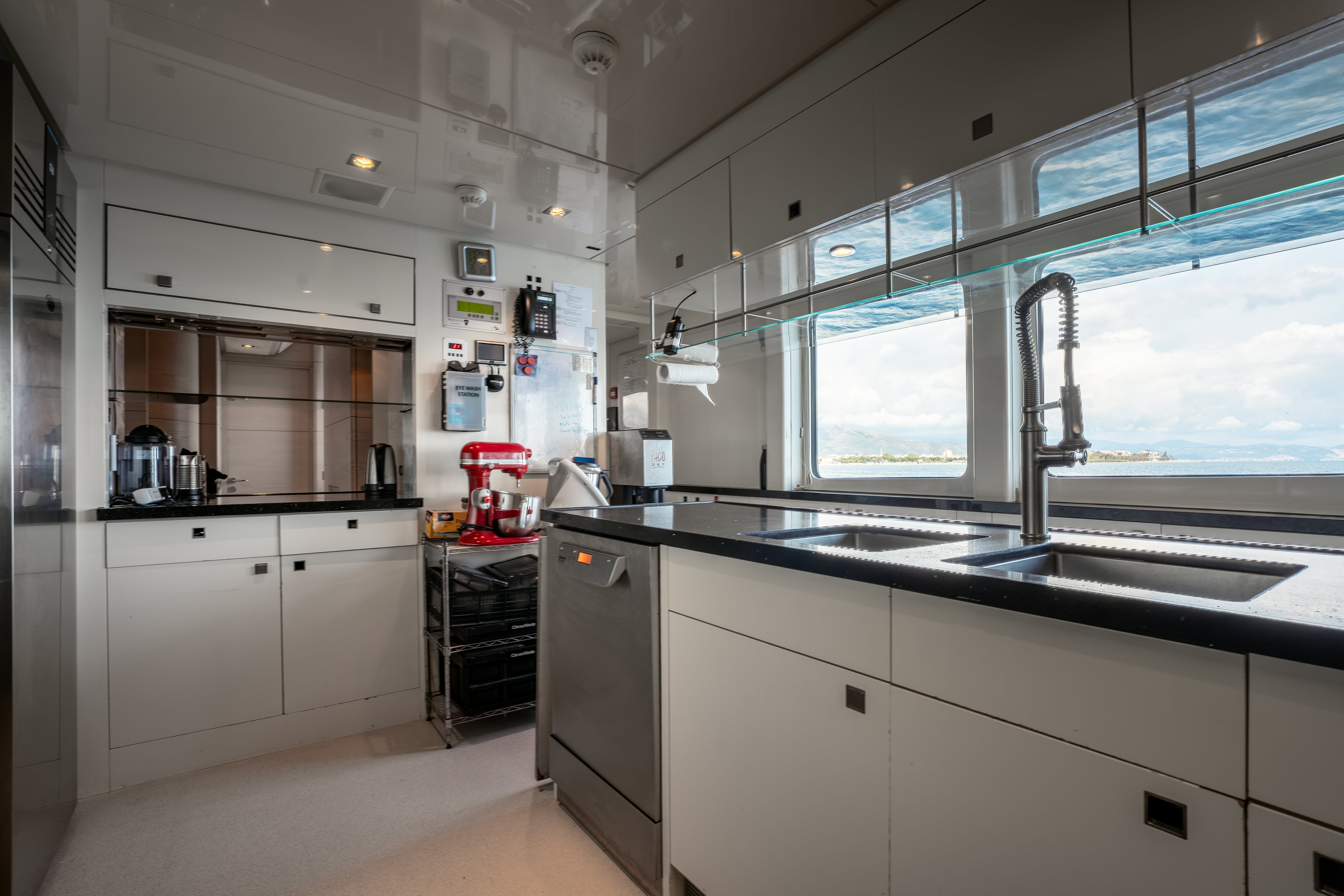 a kitchen with white cabinets aboard G3 Yacht for Sale