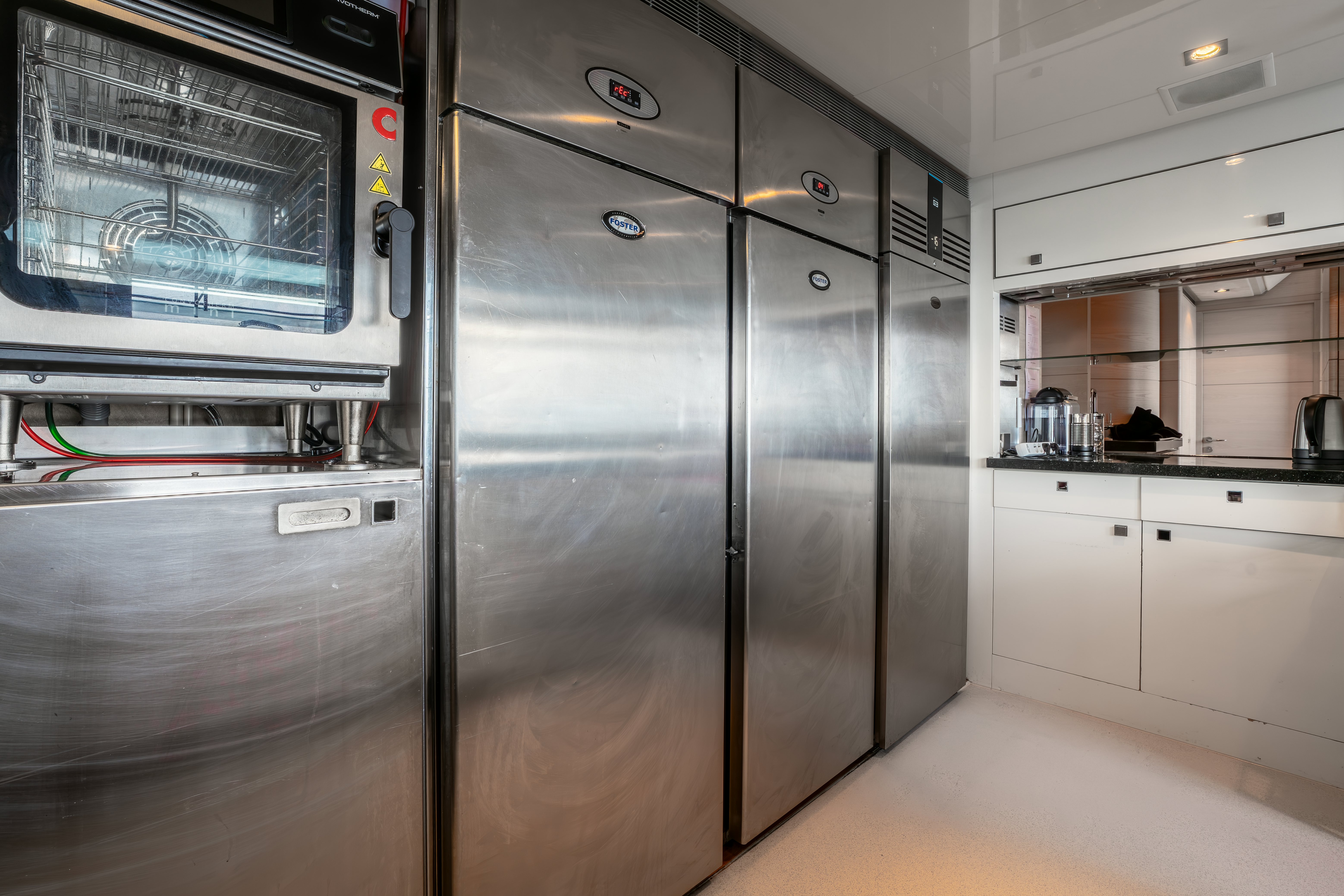 a large kitchen with stainless steel appliances aboard G3 Yacht for Sale