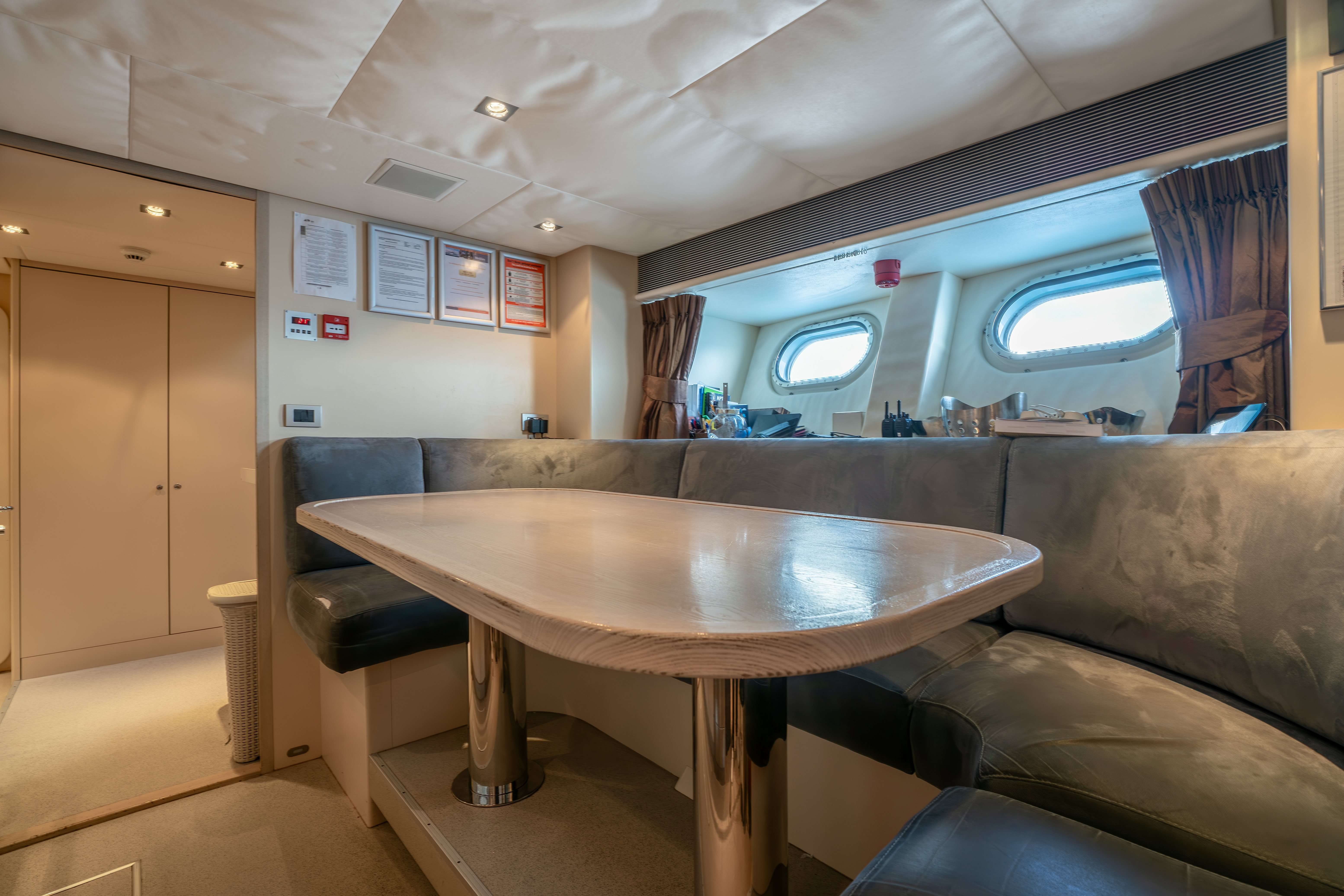a table and couch in a room aboard G3 Yacht for Sale