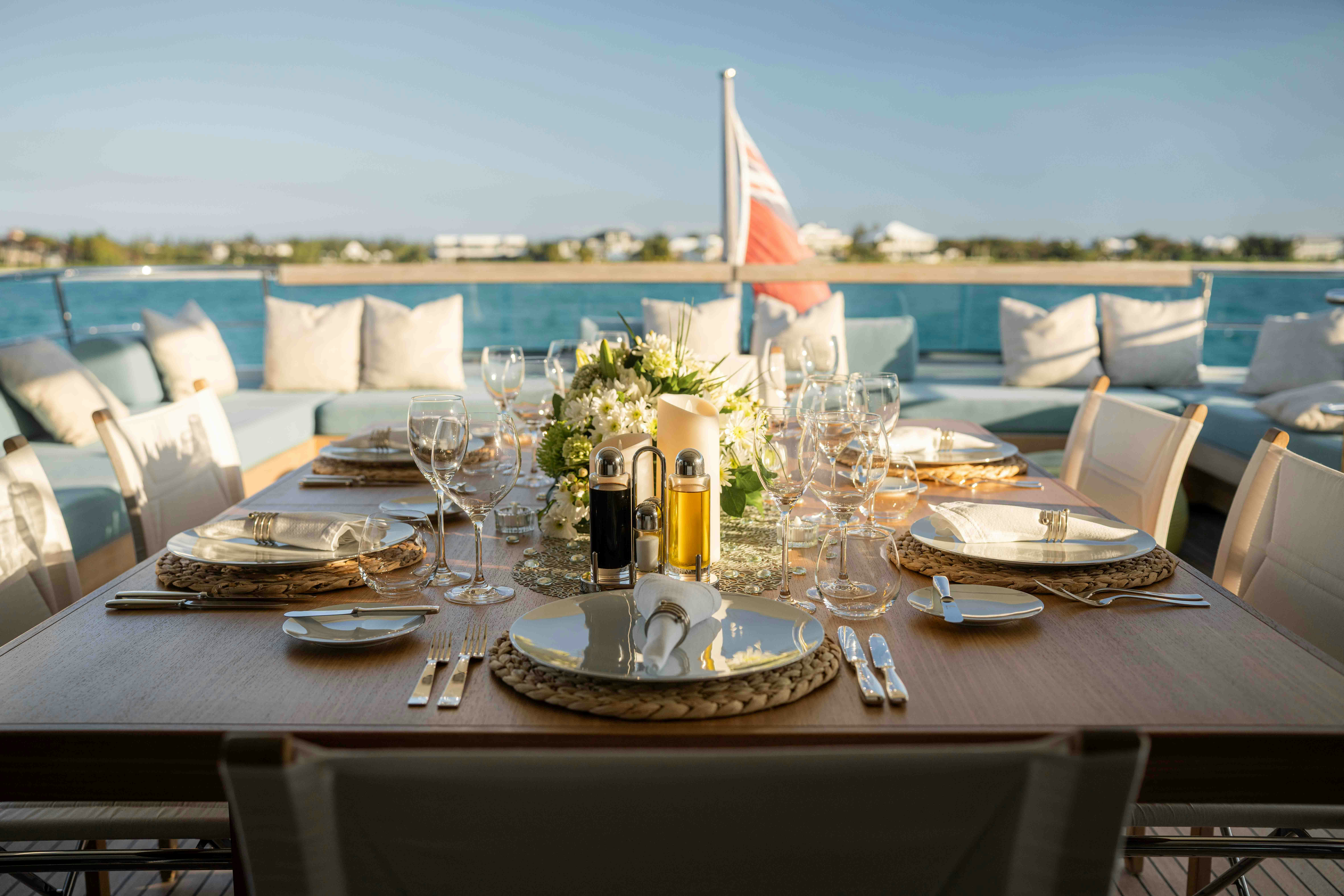 a table set with place settings aboard PREMURA Yacht for Charter