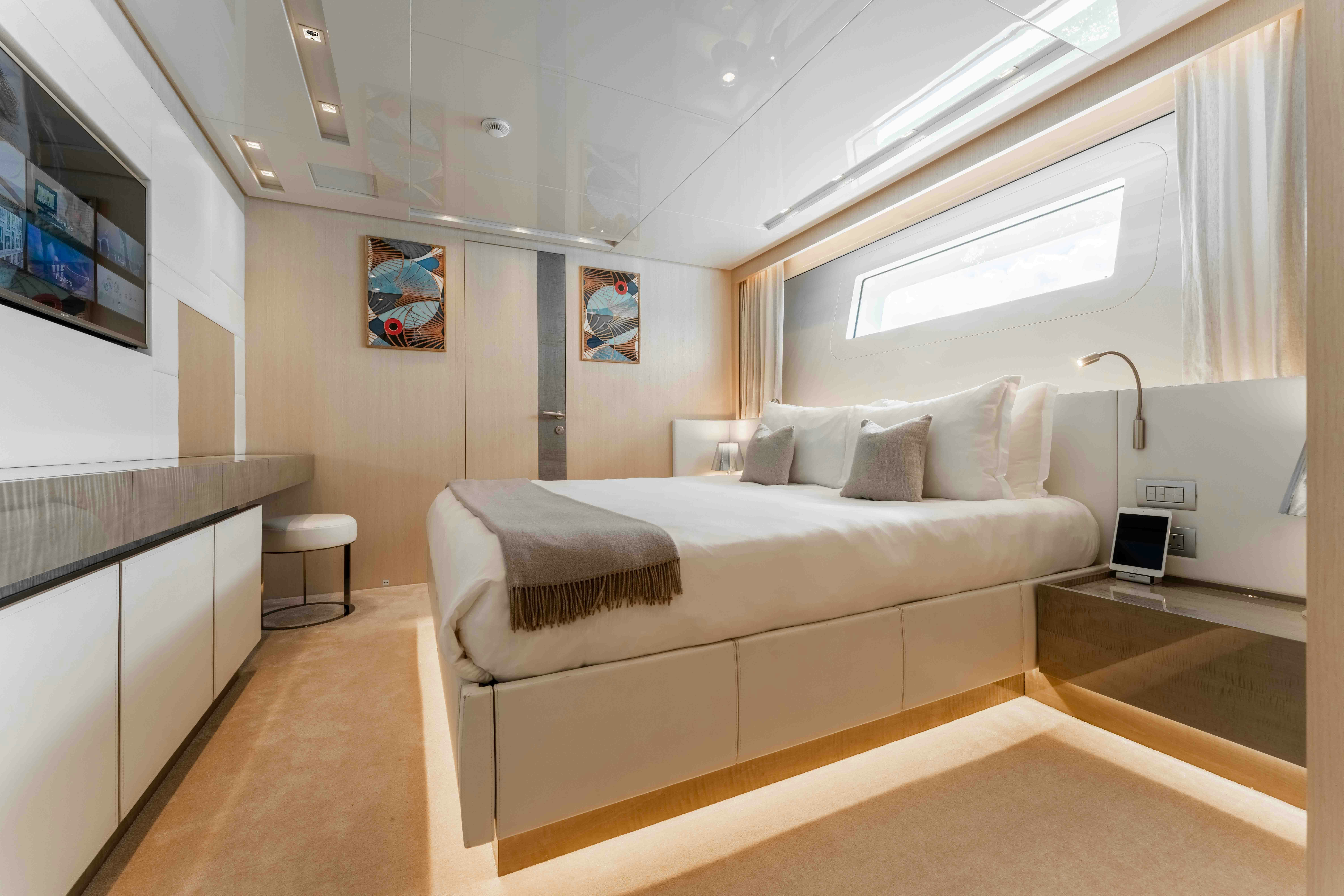a room with a bed and a desk aboard PREMURA Yacht for Charter