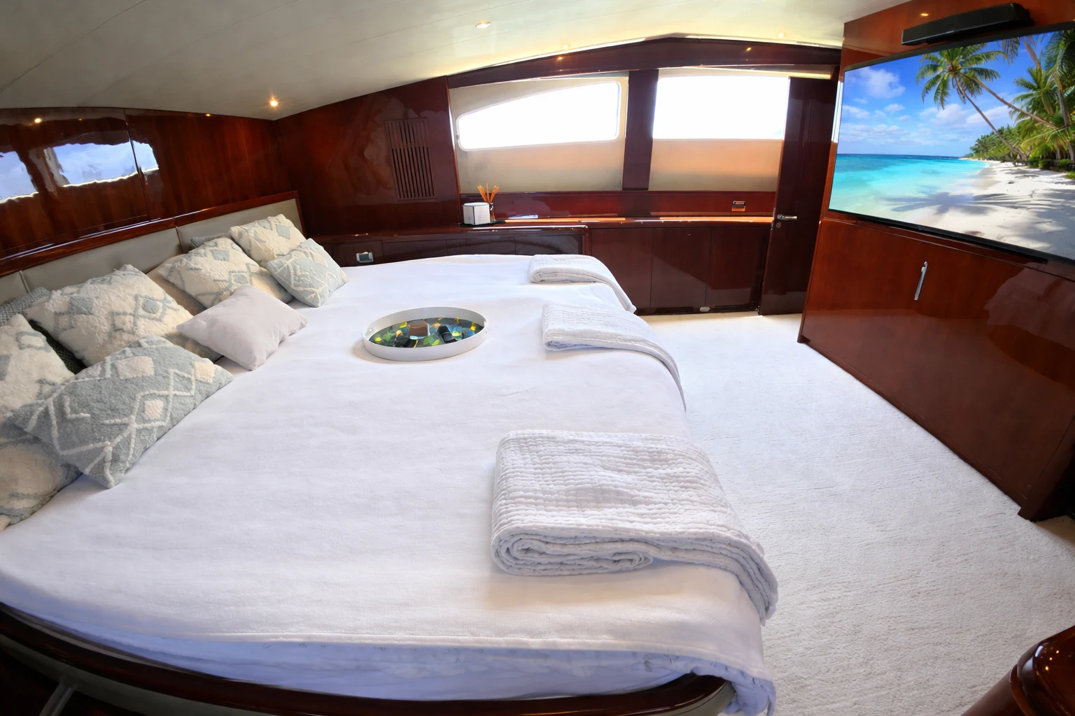 a bed with a white bed spread aboard NORTHSTAR I Yacht for Sale
