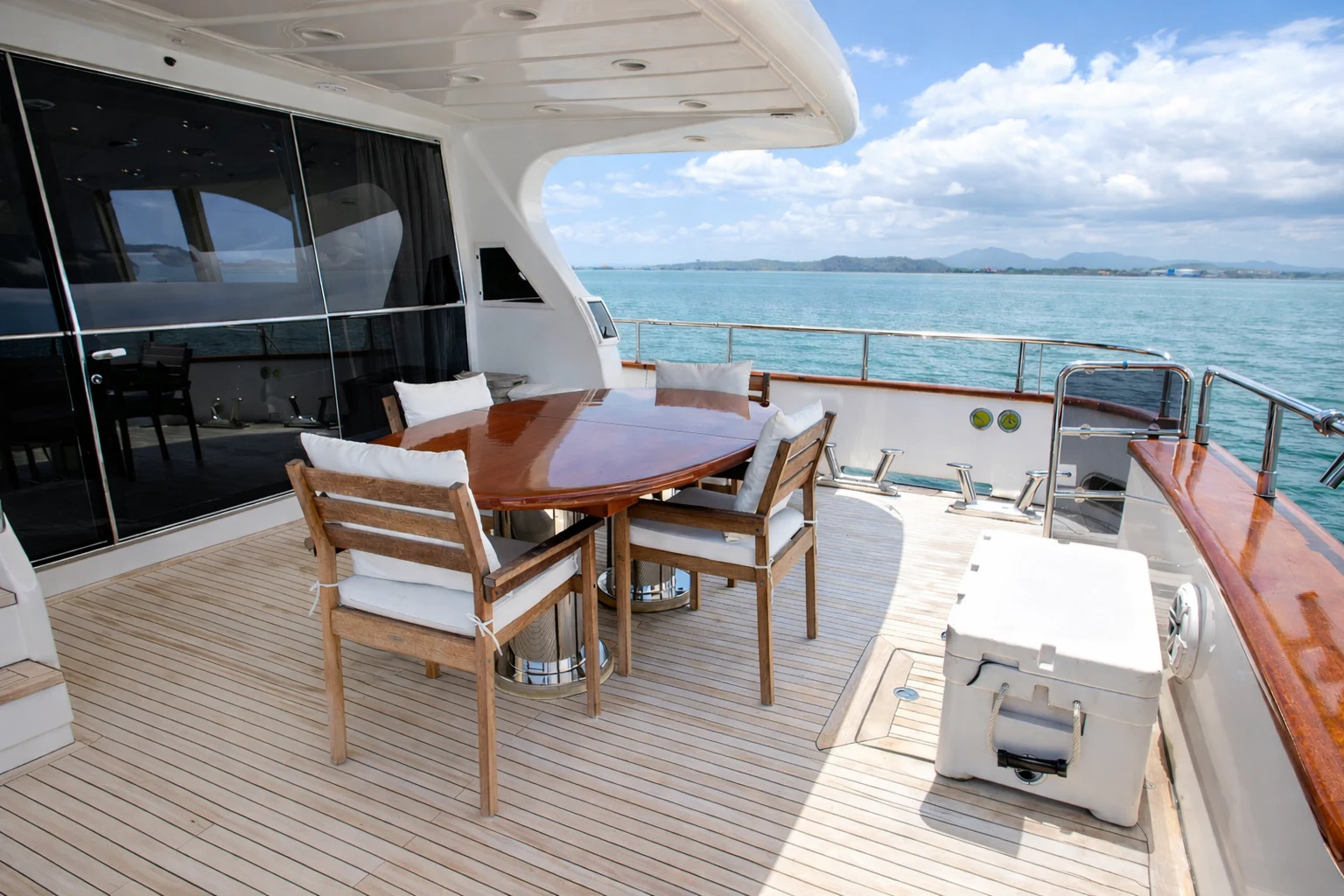 a deck with a table and chairs on it aboard NORTHSTAR I Yacht for Sale