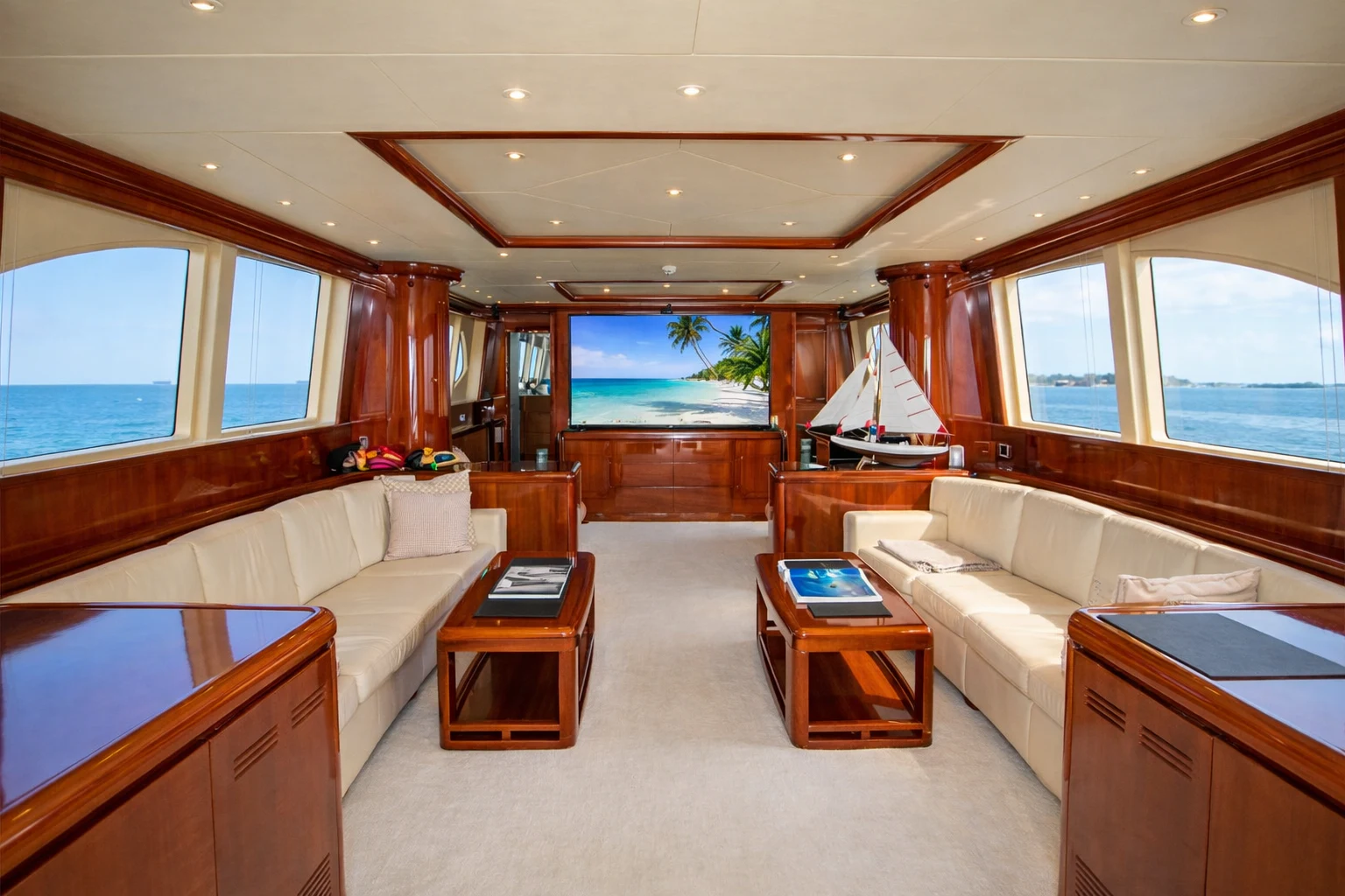 a living room with a large window aboard NORTHSTAR I Yacht for Sale