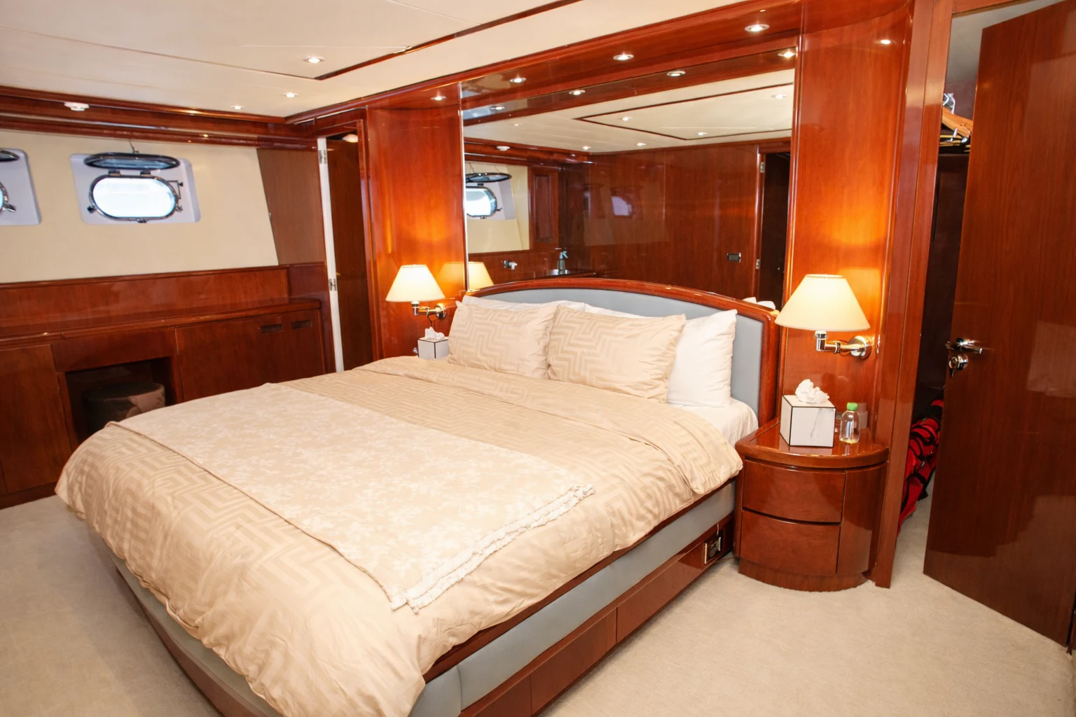 a bed with lamps on either side of it aboard NORTHSTAR I Yacht for Sale