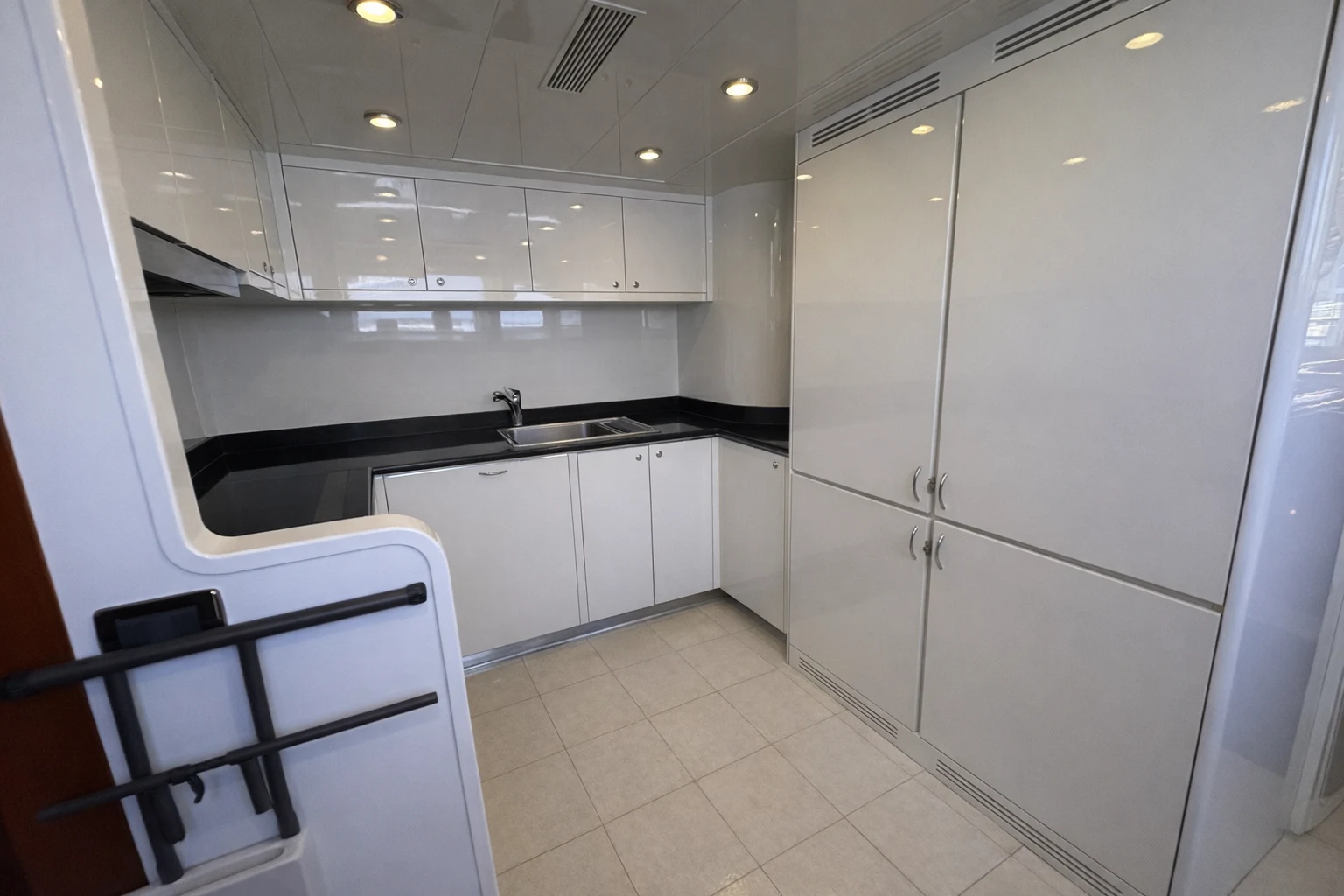 a kitchen with white cabinets aboard NORTHSTAR I Yacht for Sale