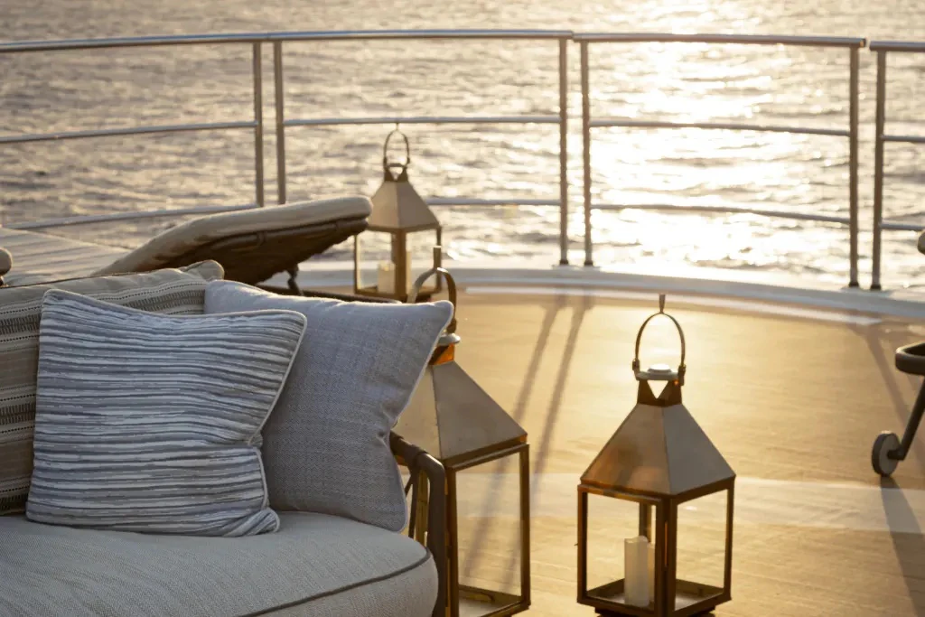 a bed and a table in a room aboard LEGEND Yacht for Charter