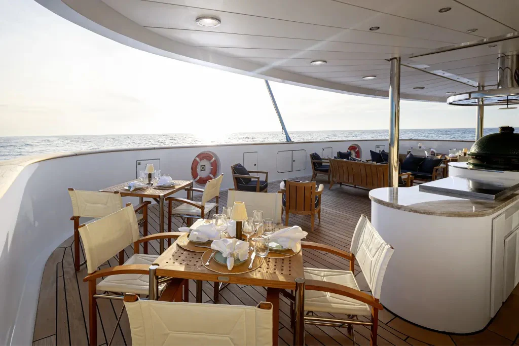 a dining room with a large table and chairs aboard LEGEND Yacht for Charter