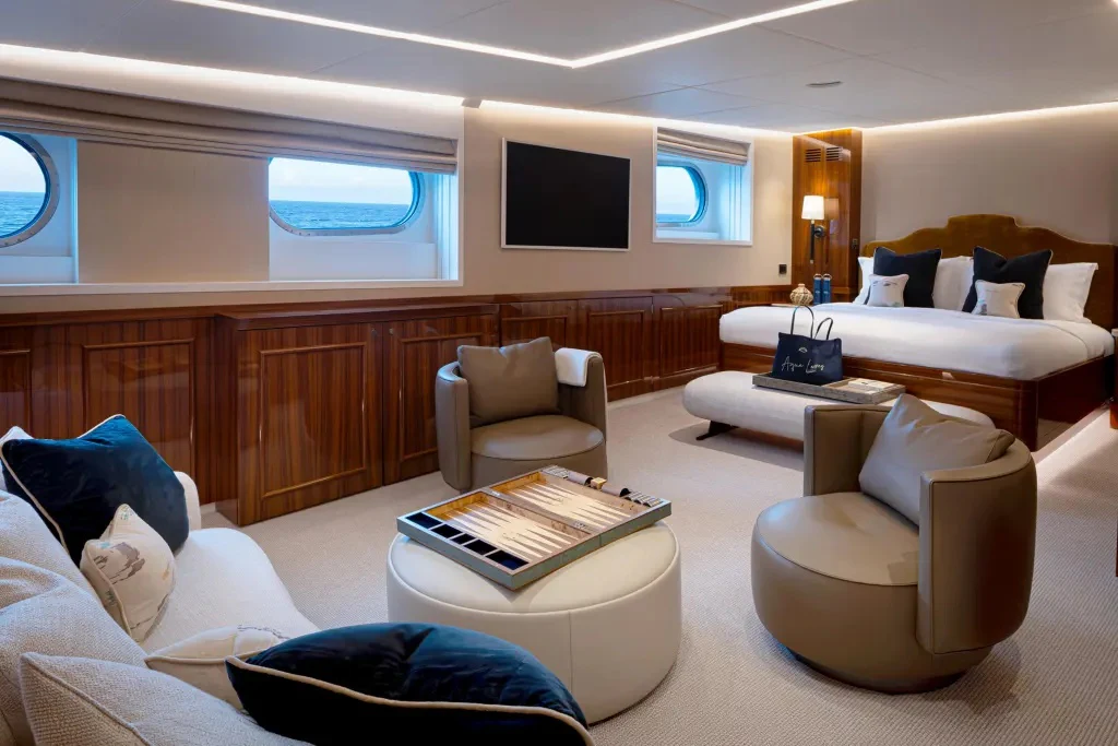 a room with a couch and a television aboard LEGEND Yacht for Charter