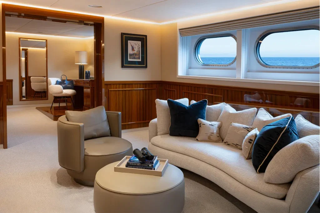a living room with a couch and a table aboard LEGEND Yacht for Charter
