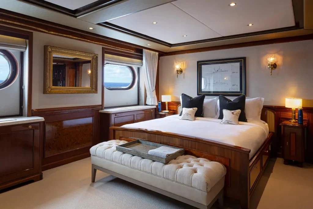 a bedroom with a bed and a television aboard LEGEND Yacht for Charter