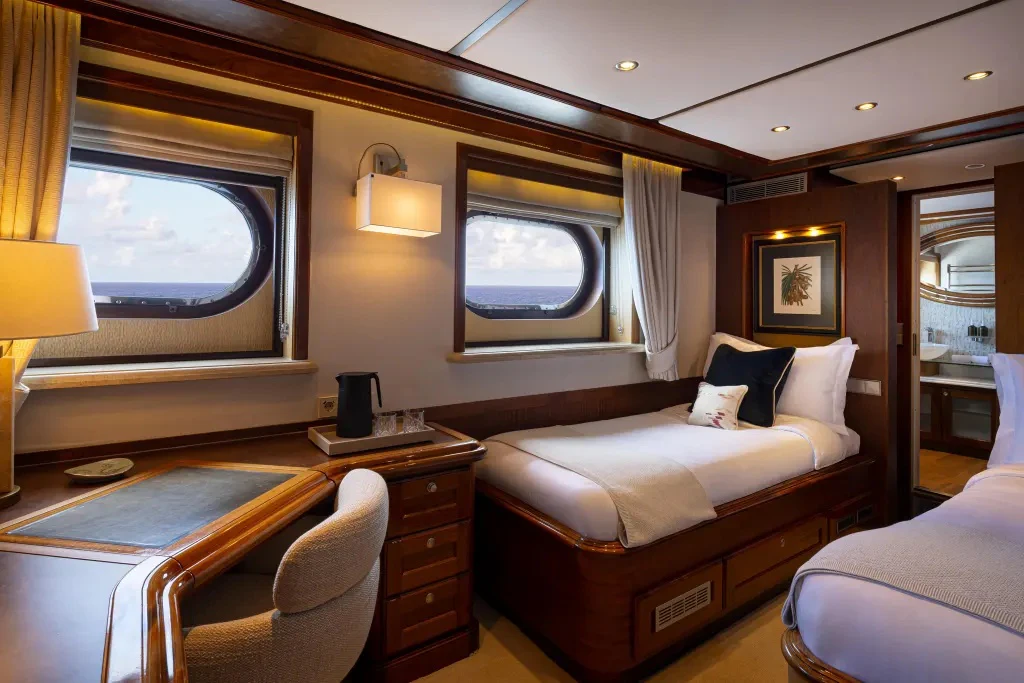 a room with a bed and a tv aboard LEGEND Yacht for Charter