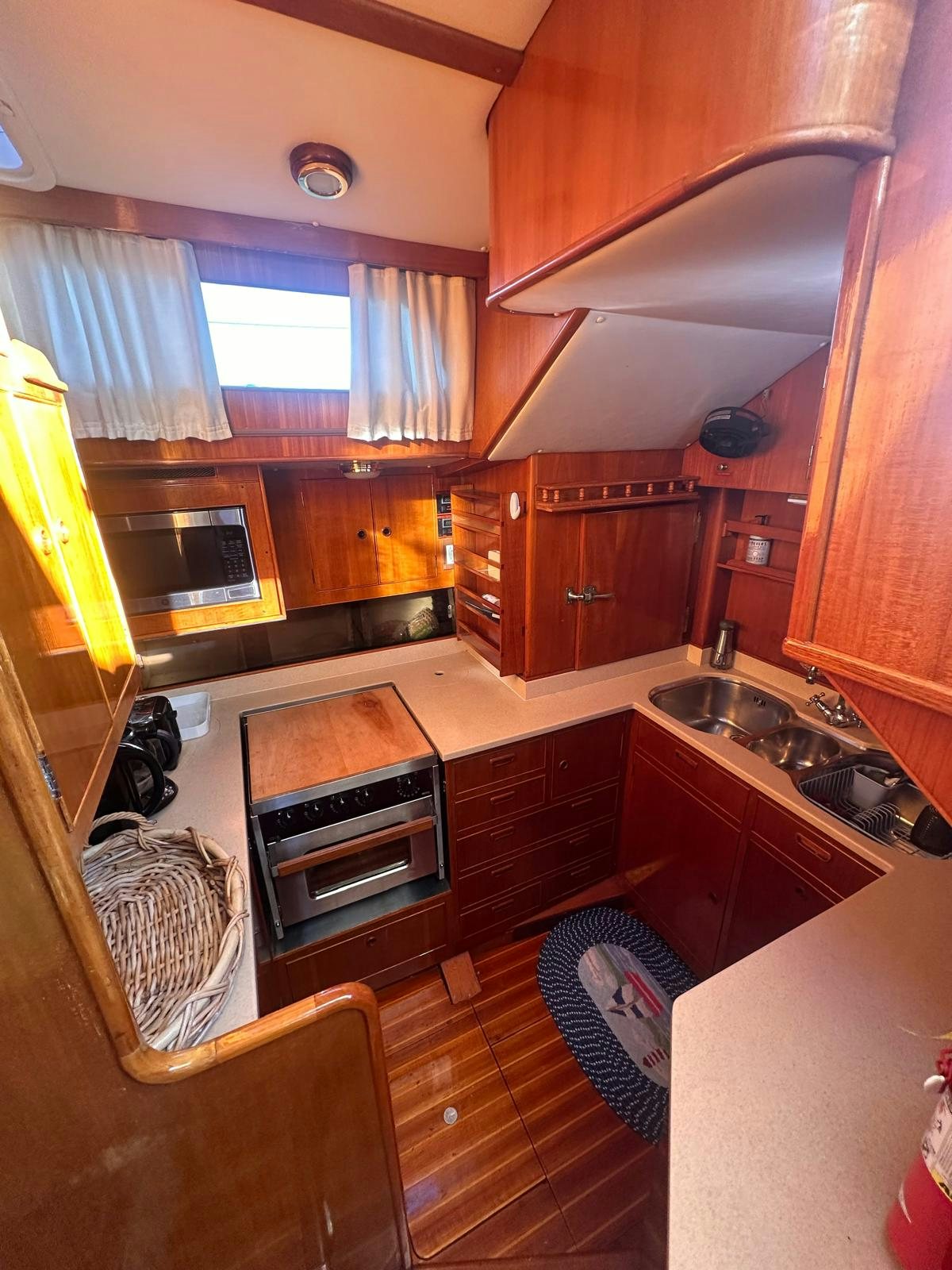 a kitchen with wooden cabinets aboard II Yacht for Sale