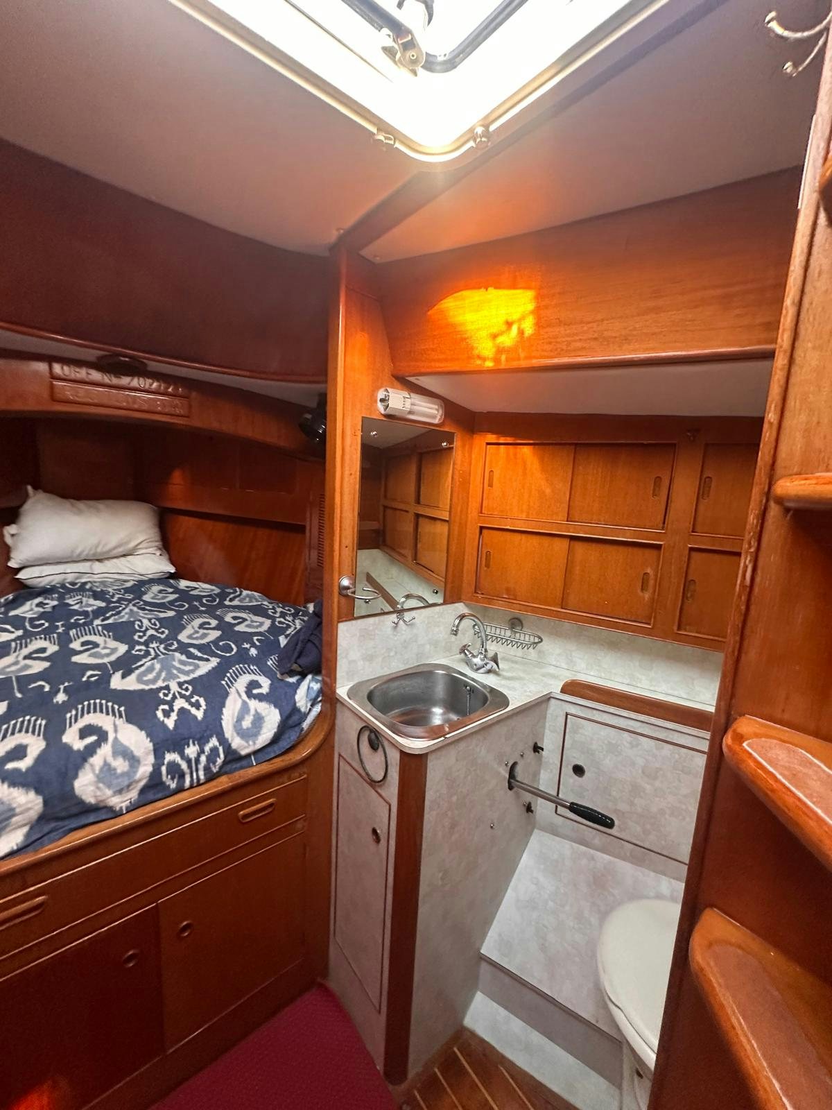 a small bathroom with a bed aboard II Yacht for Sale