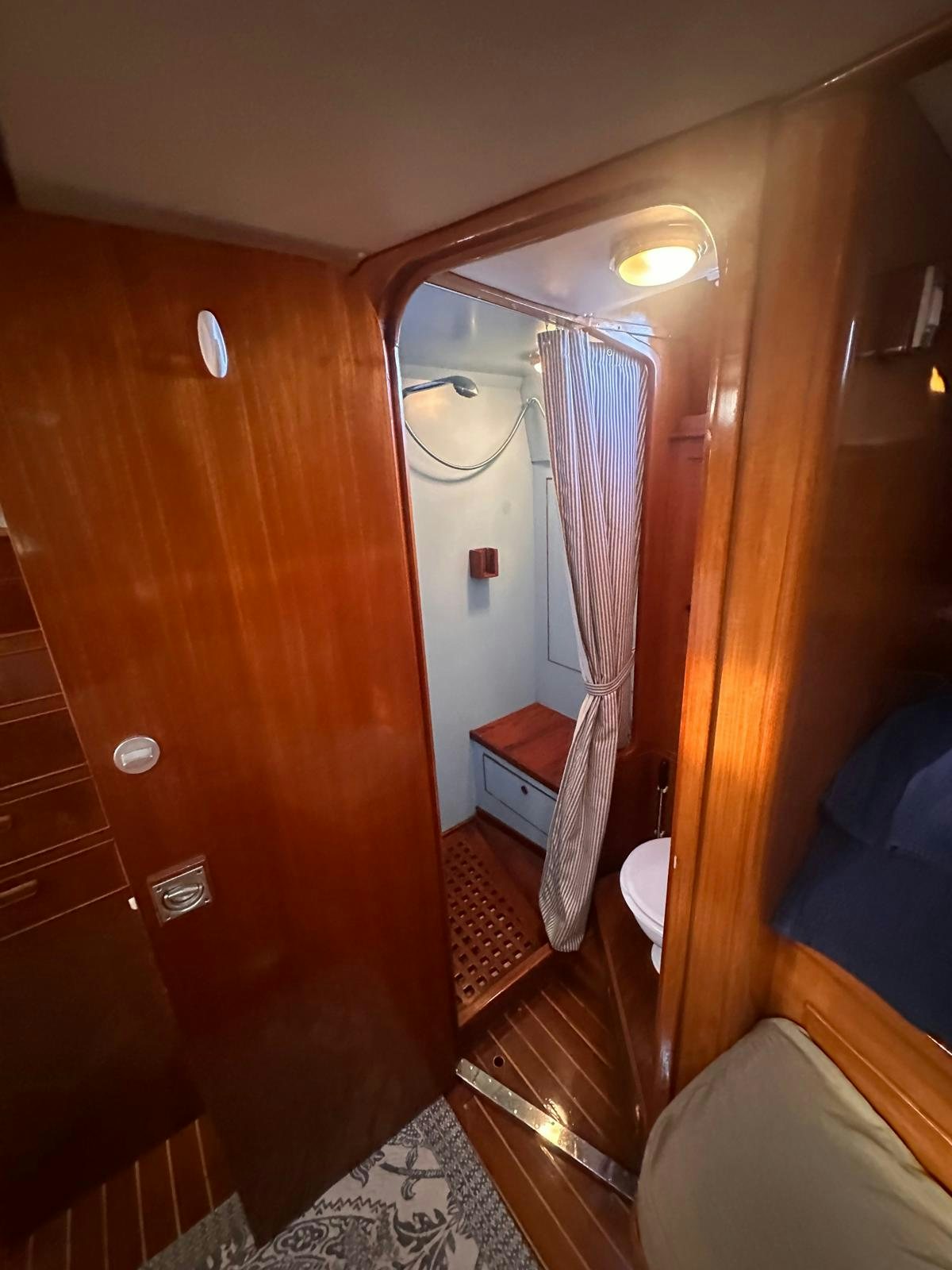 a room with a wood wall and a mirror aboard II Yacht for Sale