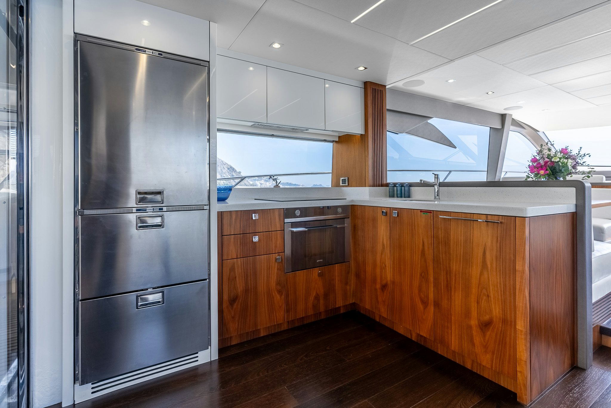 a kitchen with wooden cabinets aboard ISLA DE FLORA Yacht for Sale