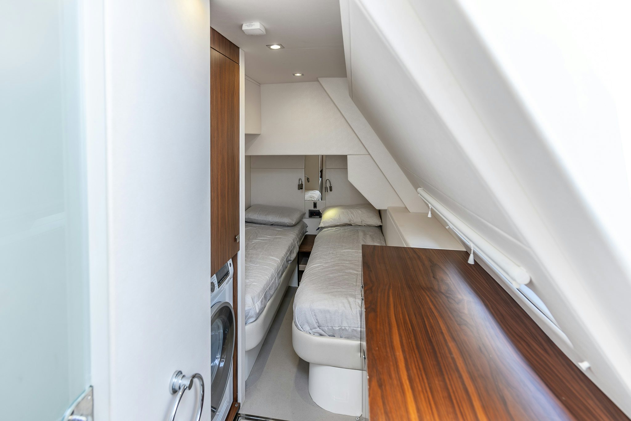 a room with a bed and a wood floor aboard ISLA DE FLORA Yacht for Sale