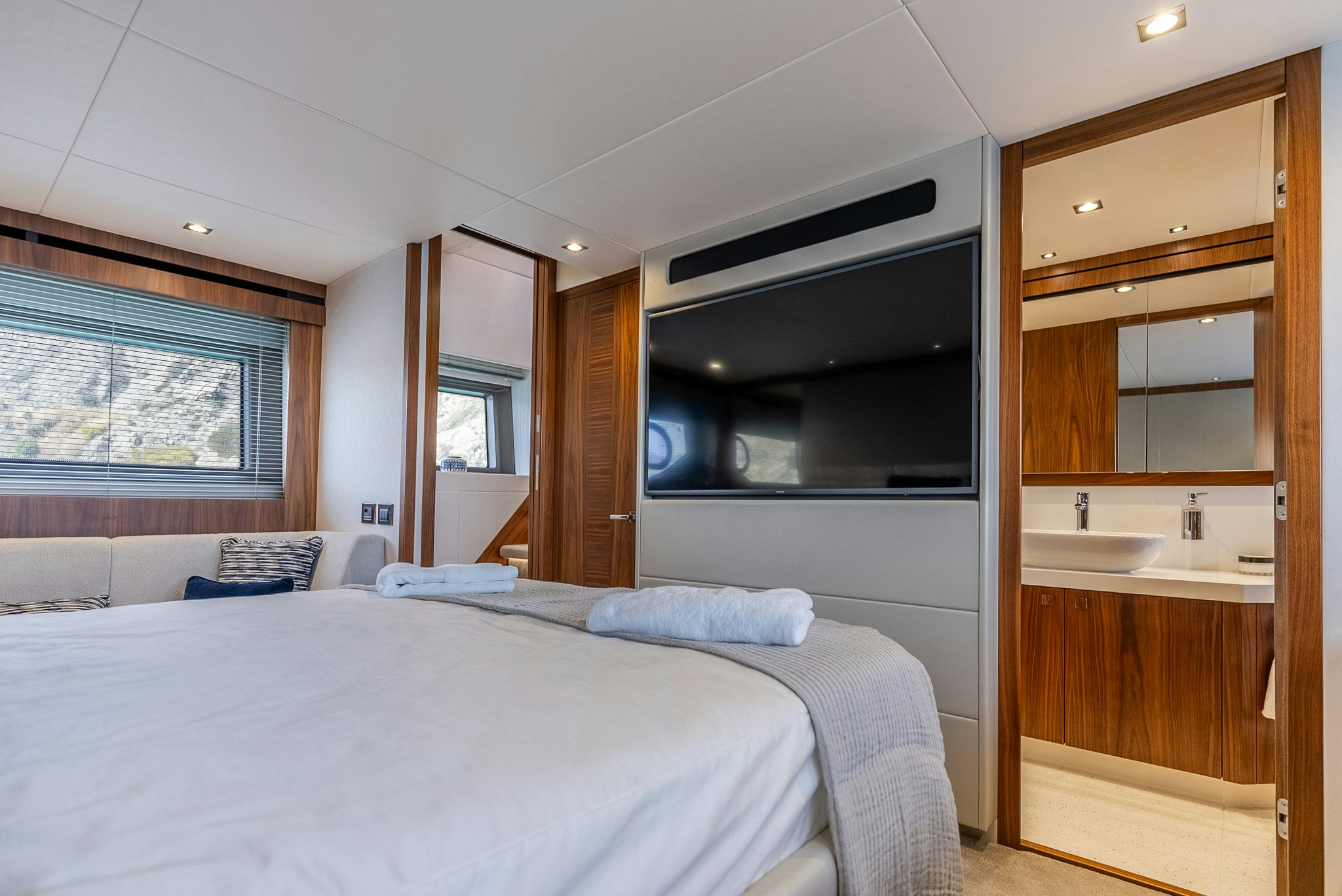 a bedroom with a bed and a microwave aboard ISLA DE FLORA Yacht for Sale