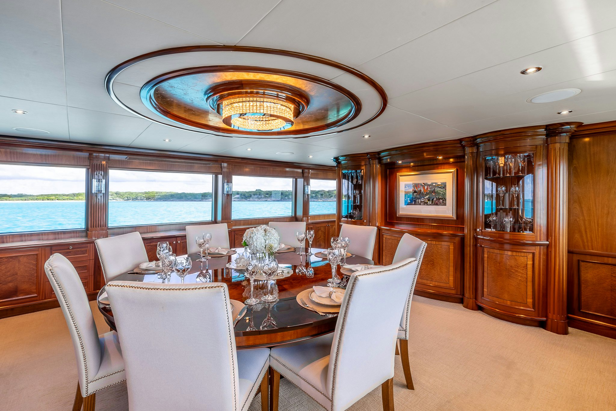a dining room with a large chandelier aboard CALLIOPE Yacht for Sale