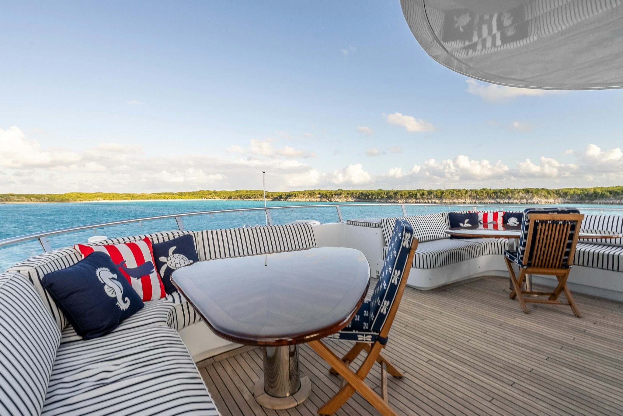 a deck with chairs and a table on it aboard CALLIOPE Yacht for Sale