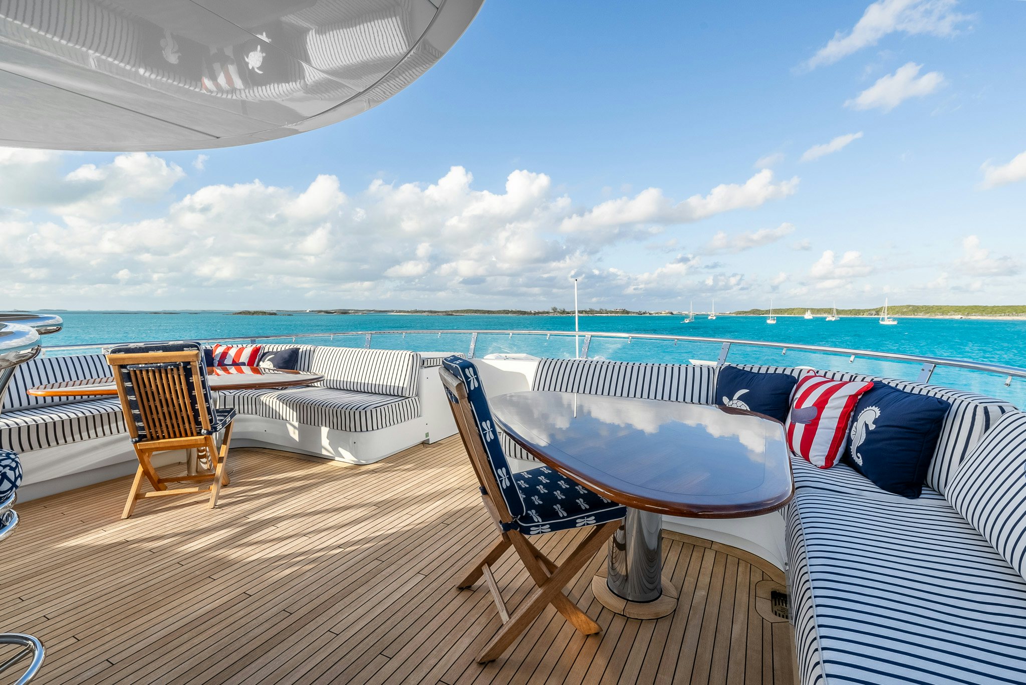 a deck with chairs and a table on it aboard CALLIOPE Yacht for Sale