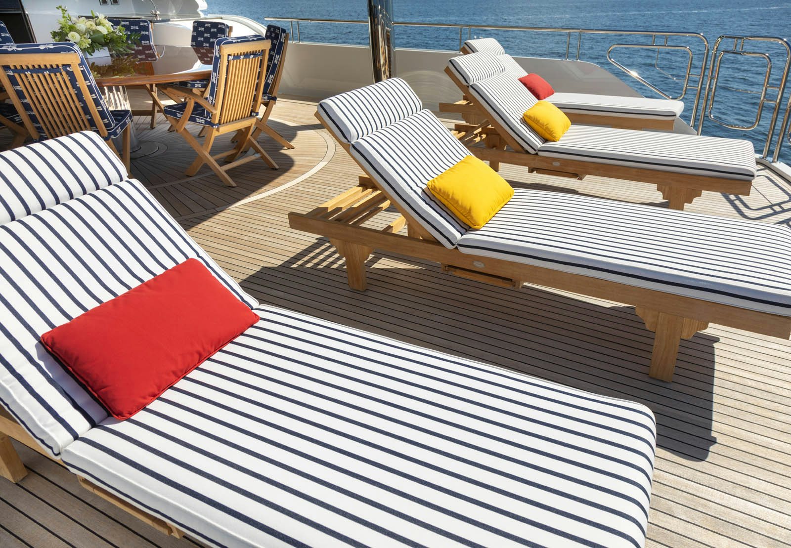 a deck with a table and chairs aboard CALLIOPE Yacht for Sale