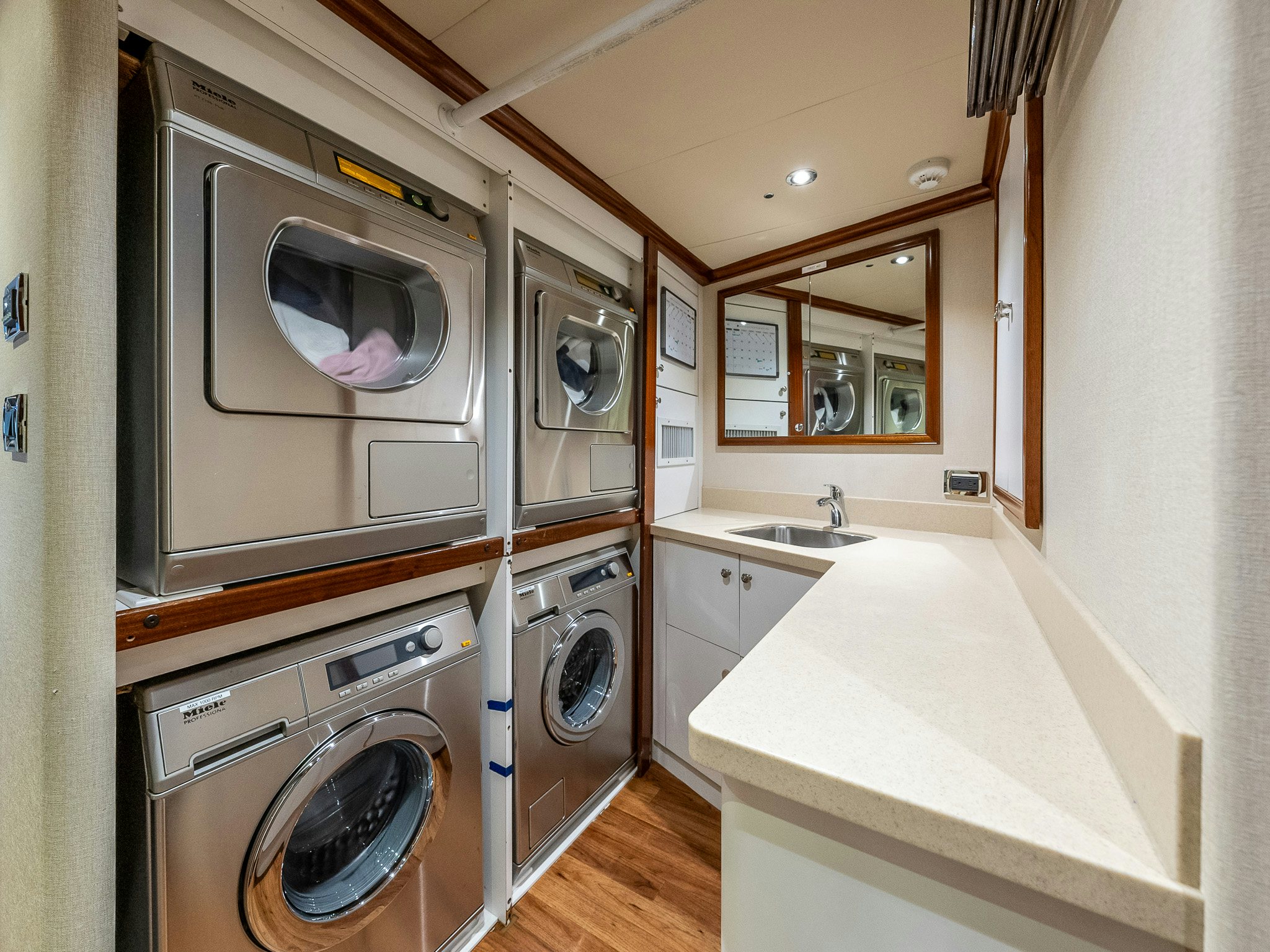 a kitchen with a washing machine and washer aboard CALLIOPE Yacht for Sale