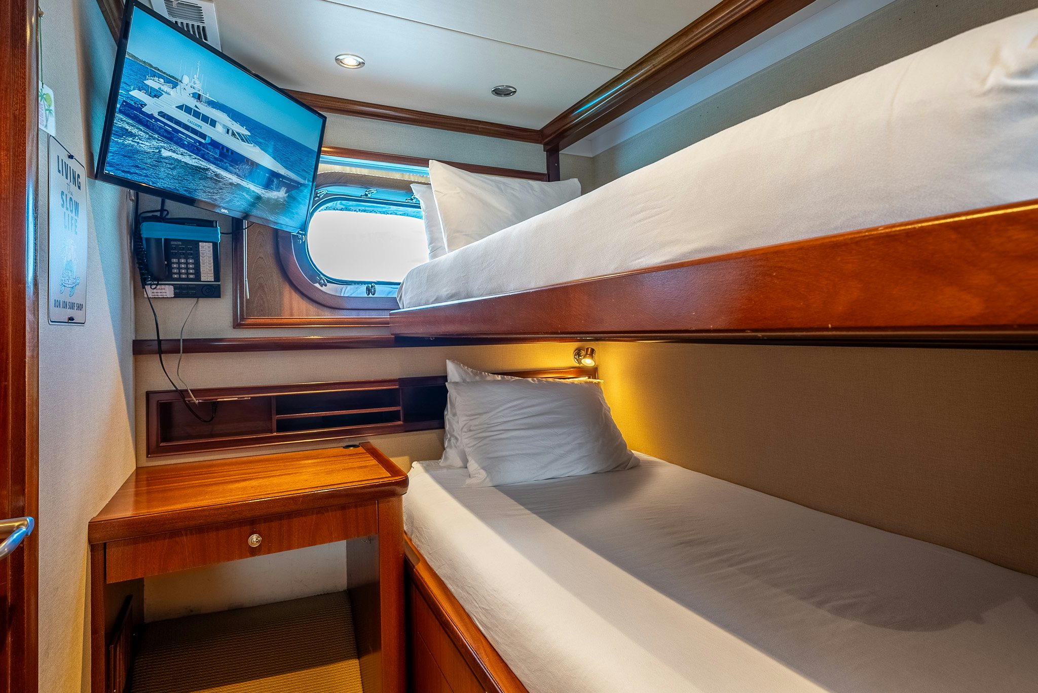 a bed with a television on the wall aboard CALLIOPE Yacht for Sale
