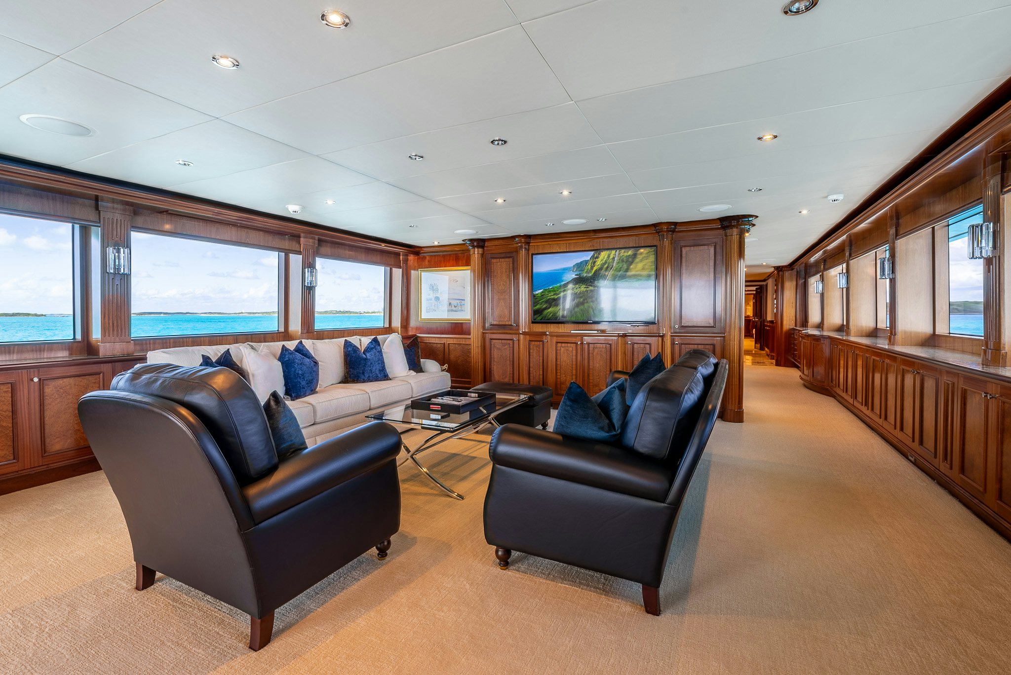 a living room with a couch and a tv aboard CALLIOPE Yacht for Sale