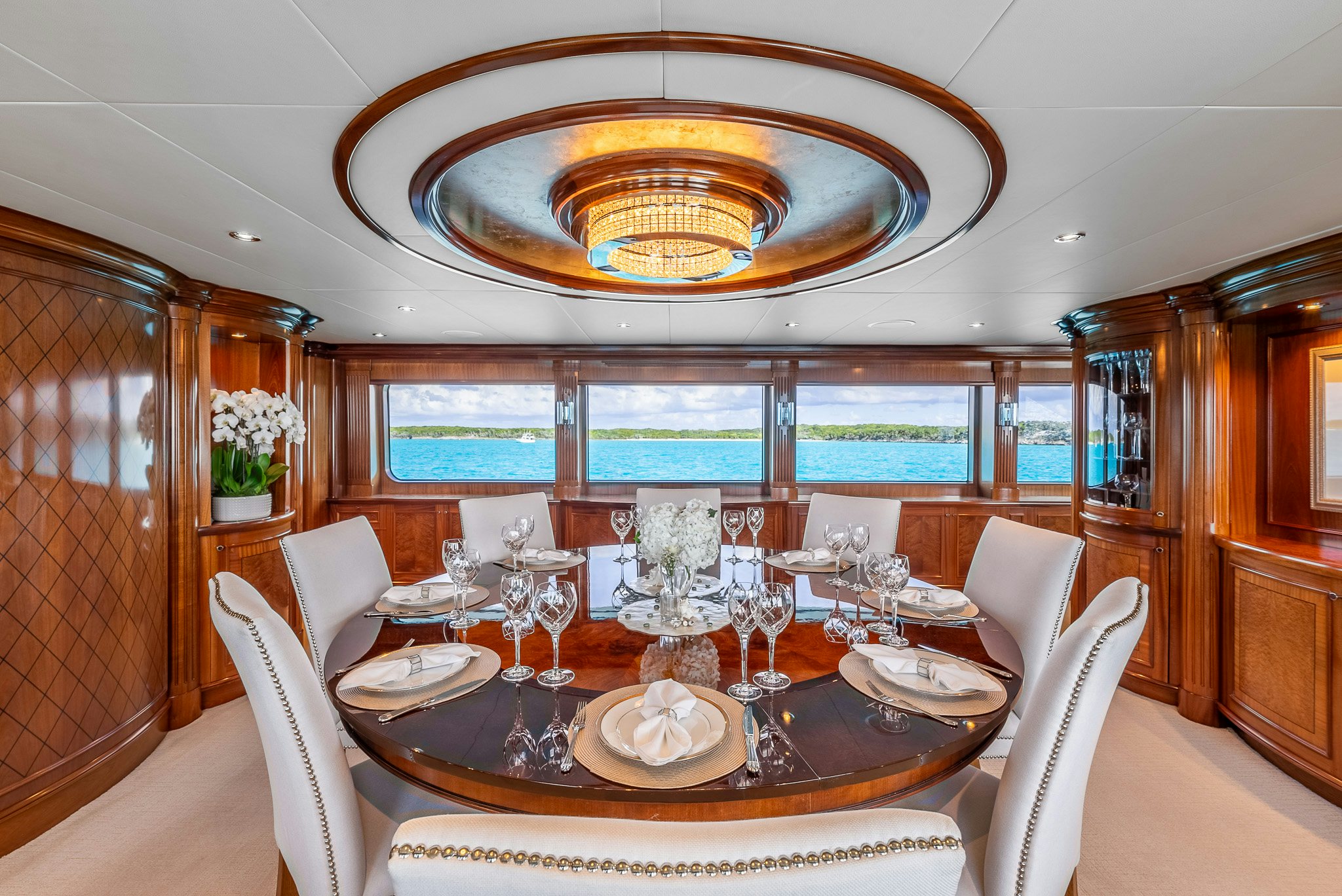 a dining room with a chandelier aboard CALLIOPE Yacht for Sale