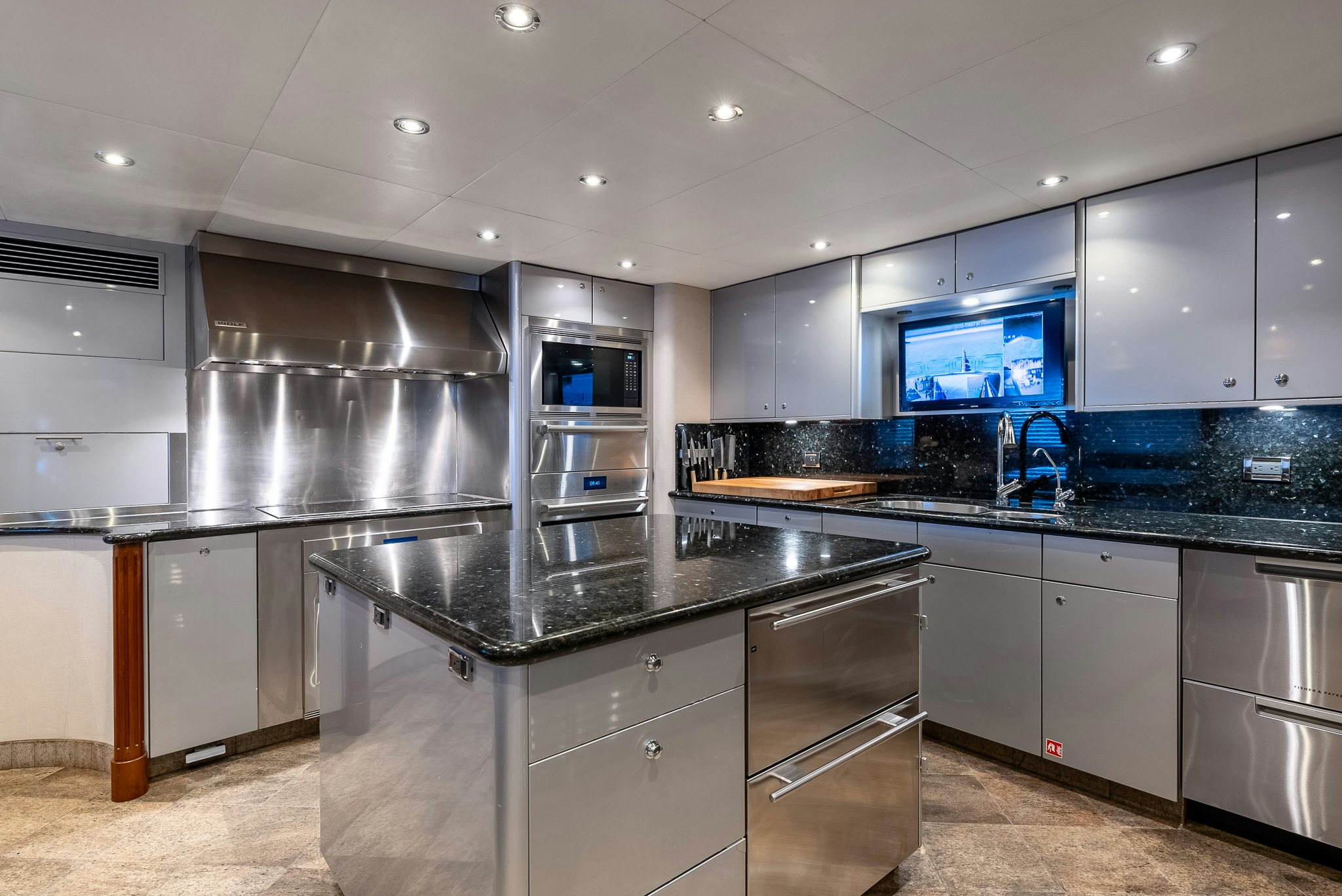 a kitchen with black counter tops aboard CALLIOPE Yacht for Sale