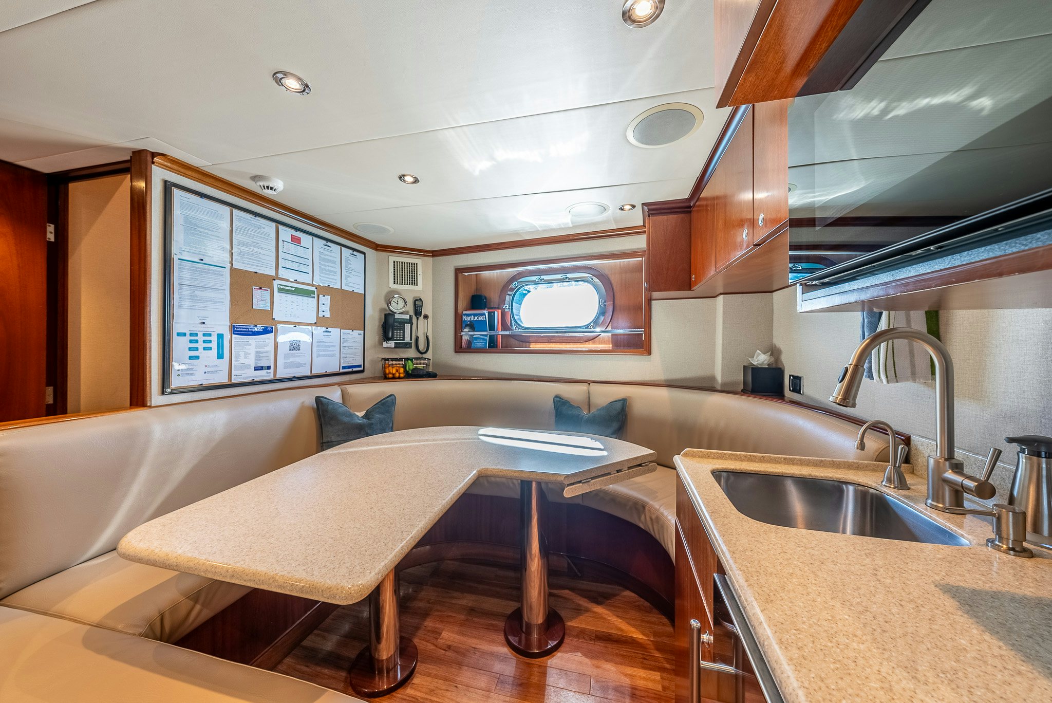 a kitchen with a table and chairs aboard CALLIOPE Yacht for Sale
