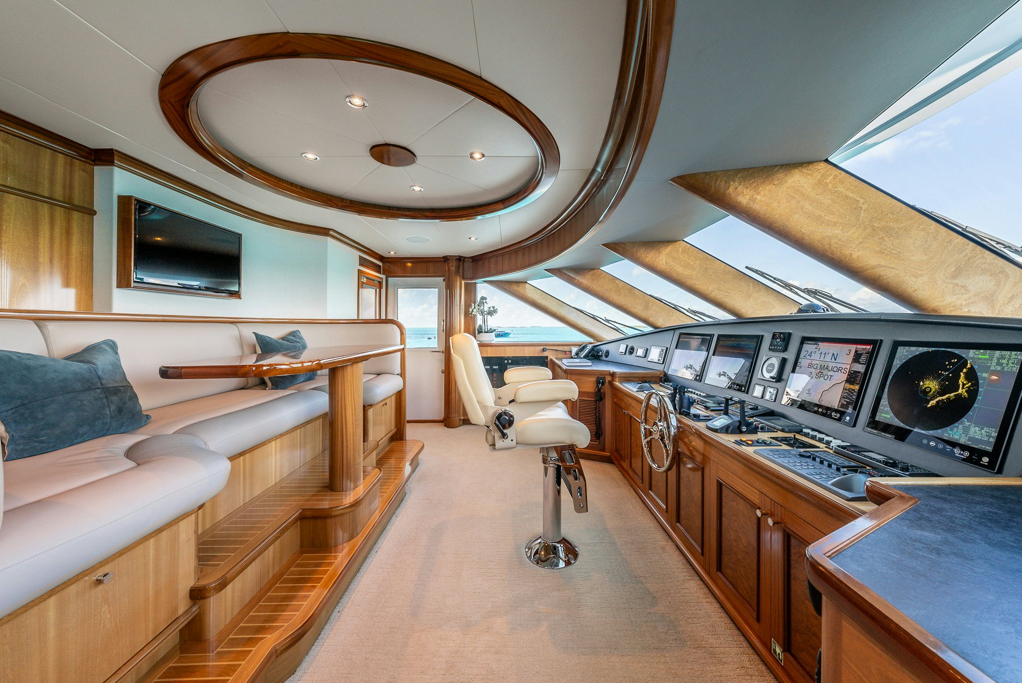 a room with a couch and a table with a computer on it aboard CALLIOPE Yacht for Sale