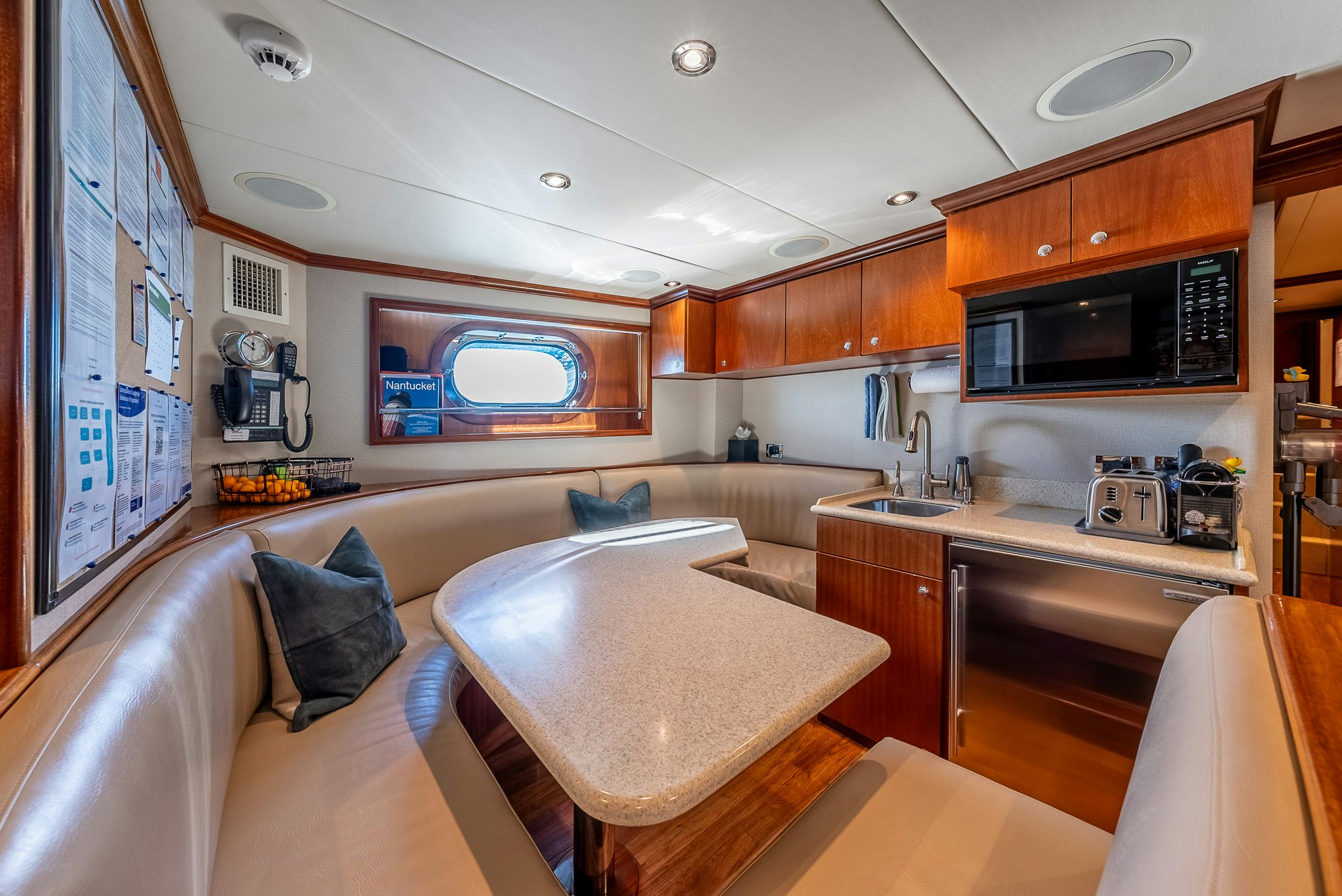 a kitchen with a table and chairs aboard CALLIOPE Yacht for Sale