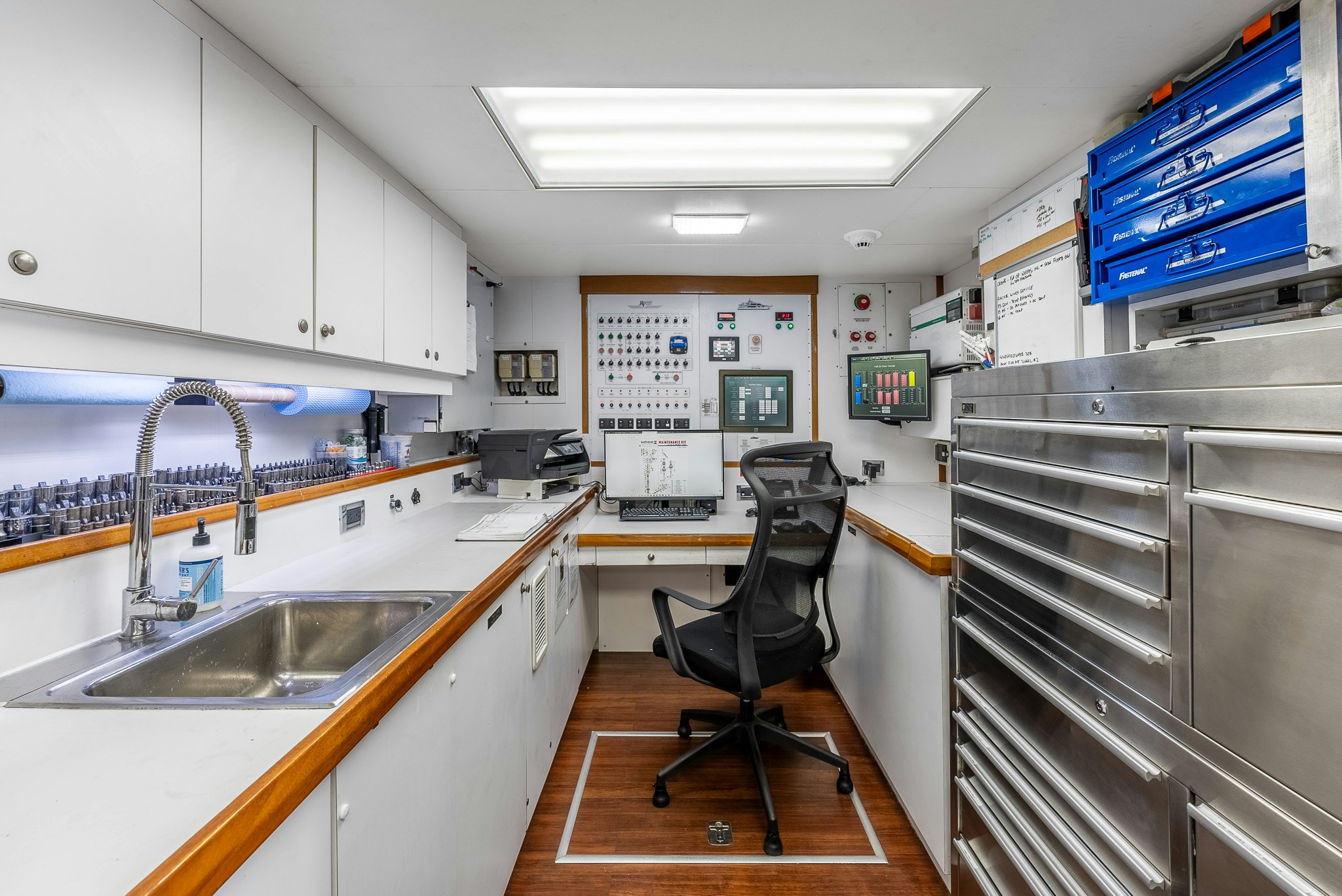 a kitchen with a sink and a chair aboard CALLIOPE Yacht for Sale
