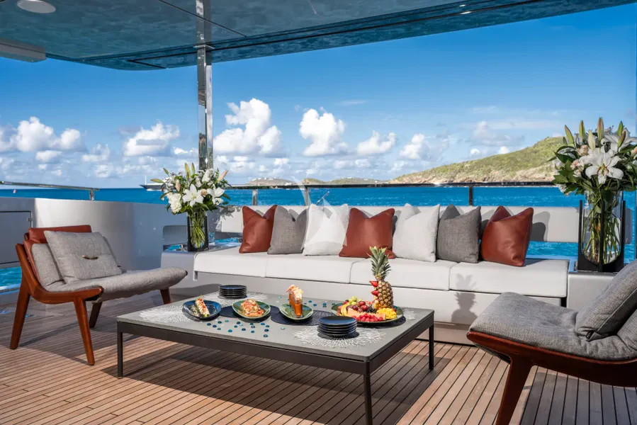 a patio with a table and chairs aboard TASTY WAVES Yacht for Charter