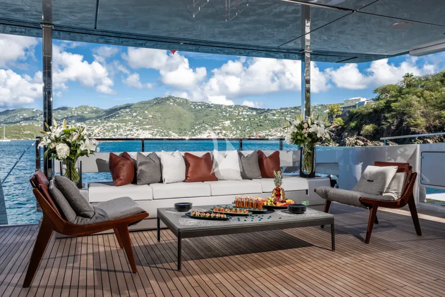 a patio with a table and chairs aboard TASTY WAVES Yacht for Charter