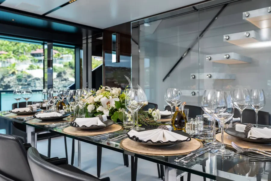 a table set with plates and glasses aboard TASTY WAVES Yacht for Charter