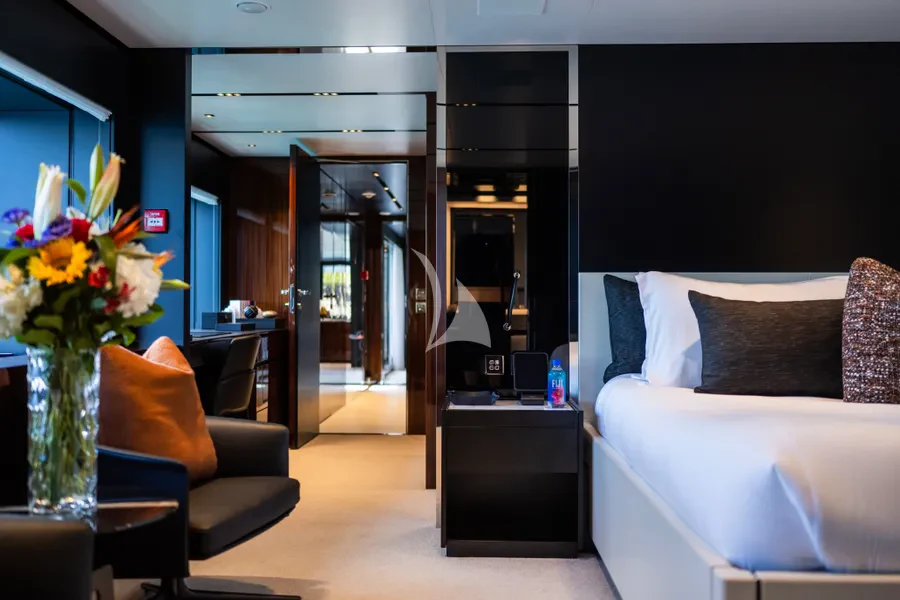 a living room with a couch and a vase of flowers aboard TASTY WAVES Yacht for Charter