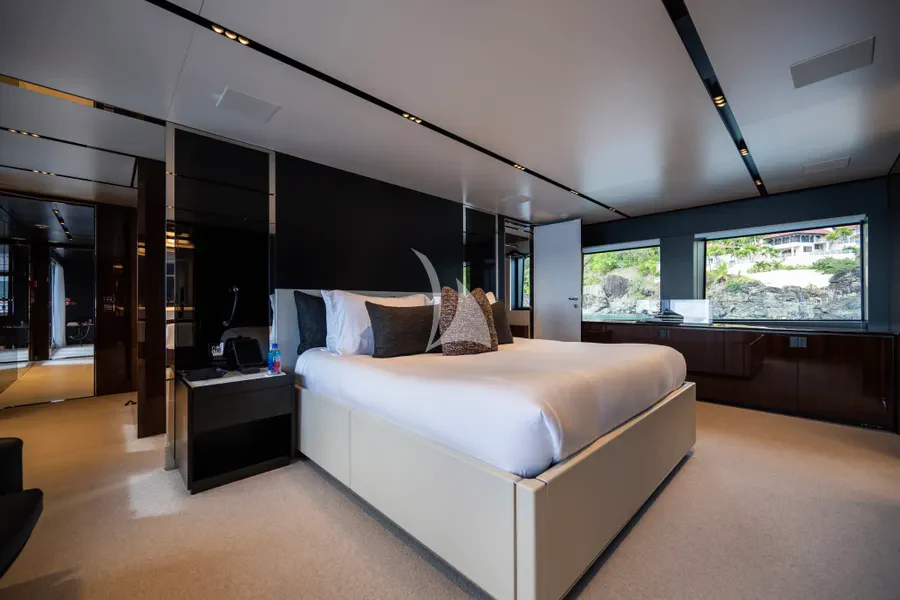 a room with a bed and a desk aboard TASTY WAVES Yacht for Charter