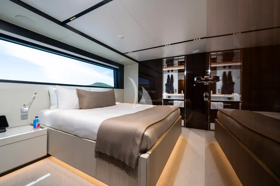 a room with a bed and a large window aboard TASTY WAVES Yacht for Charter