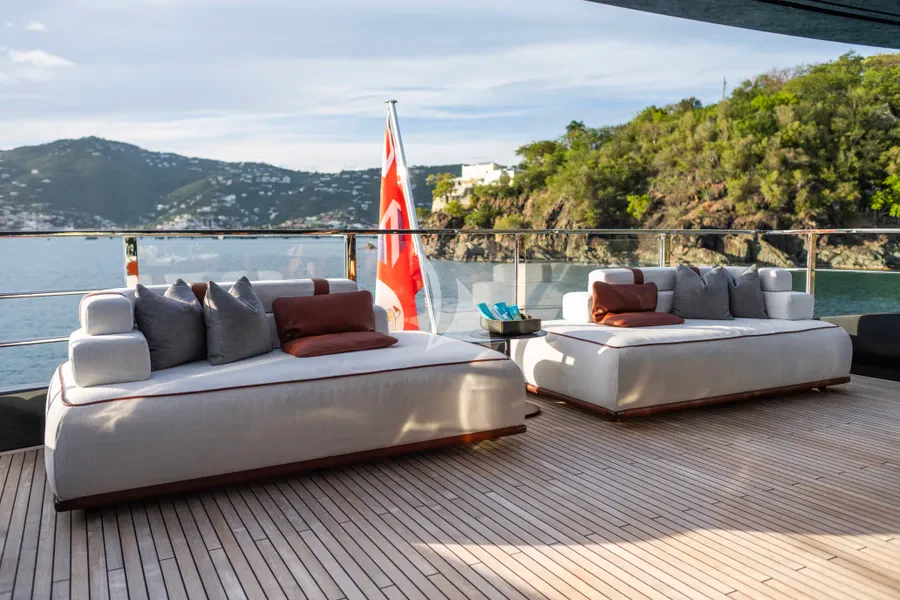 a deck with a large red sailboat on it aboard TASTY WAVES Yacht for Charter