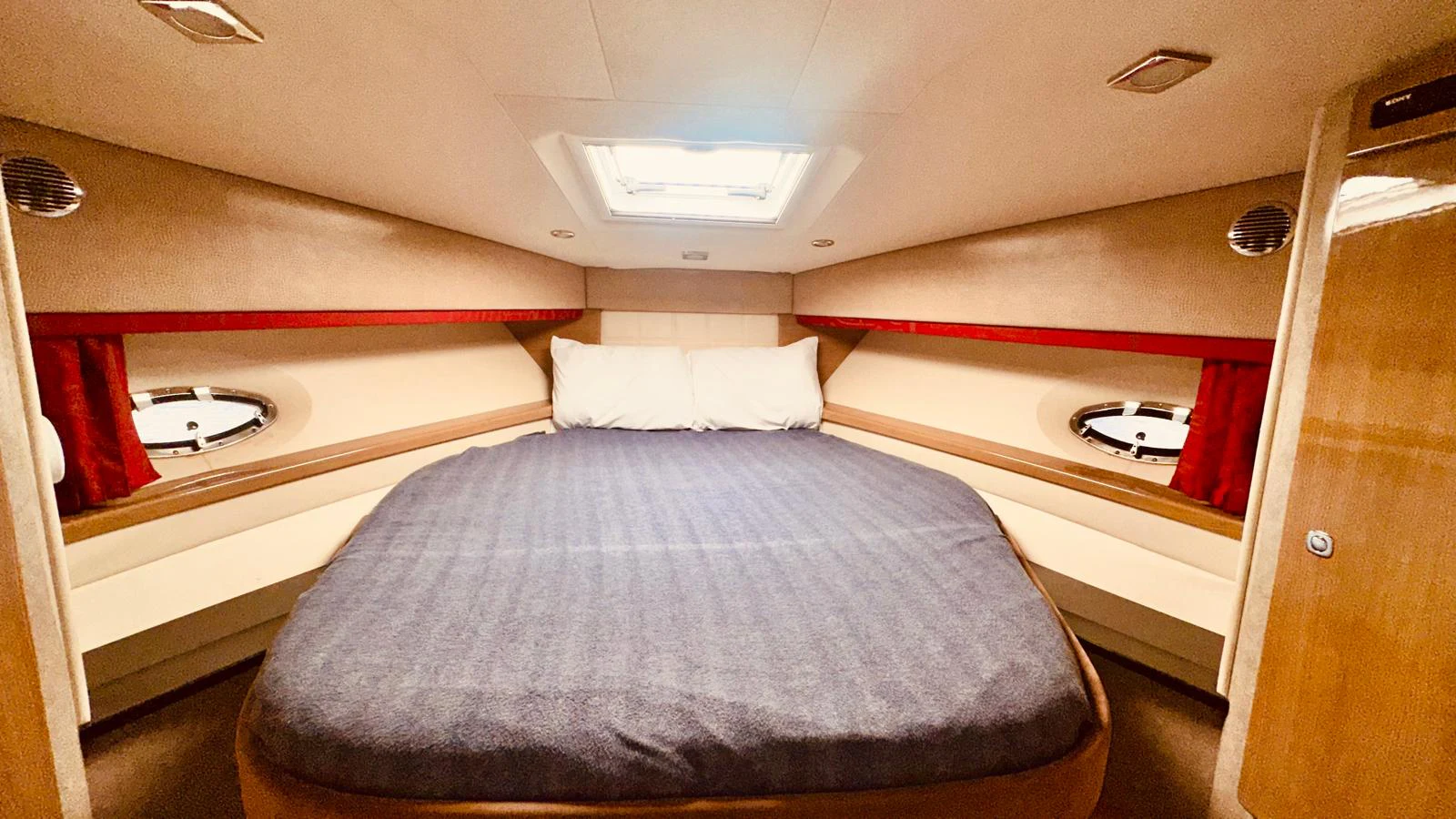 a room with a bed and a window aboard MODERATION Yacht for Sale