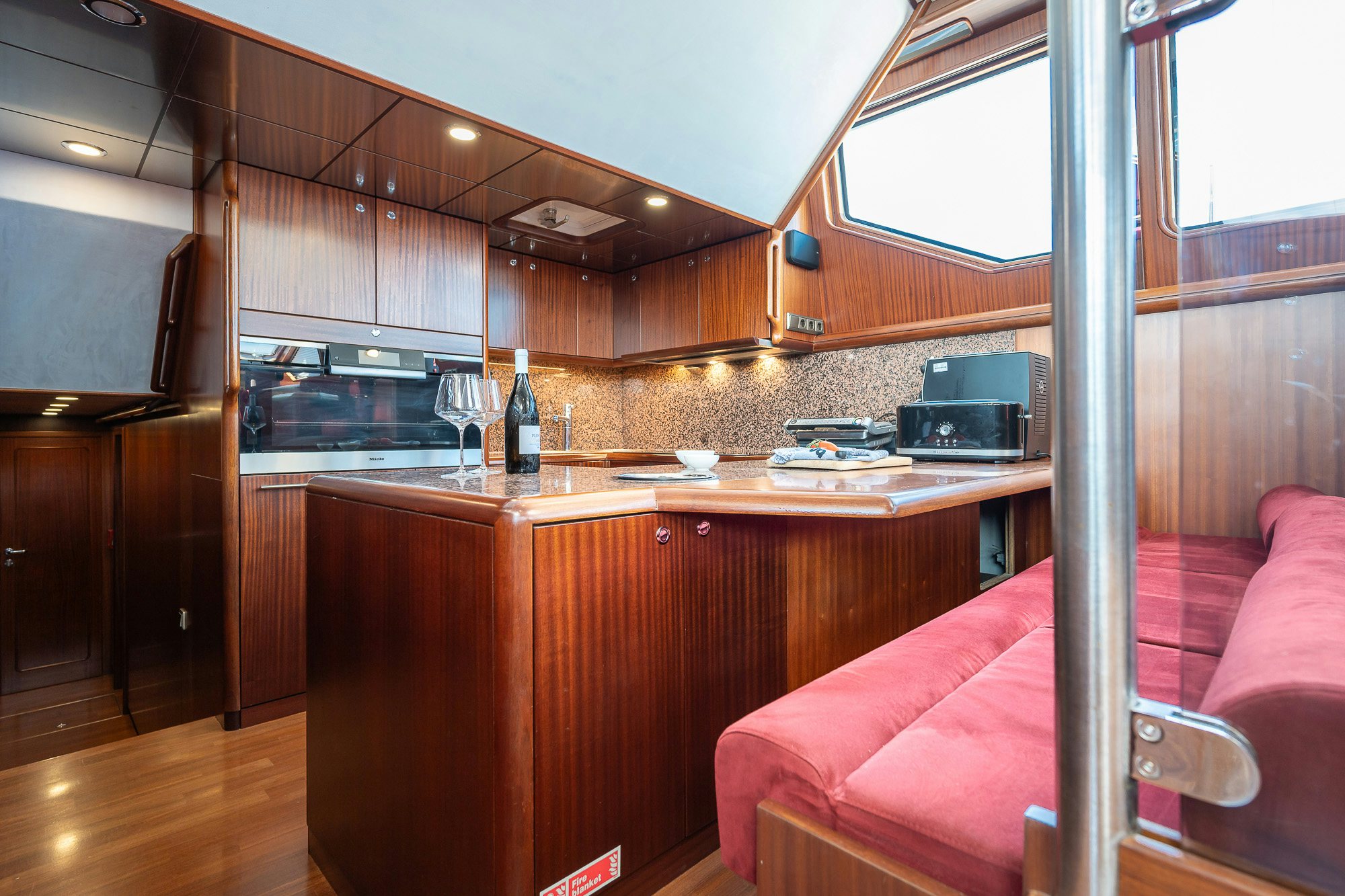 a kitchen with a pink couch aboard PLAYMOBIL Yacht for Sale