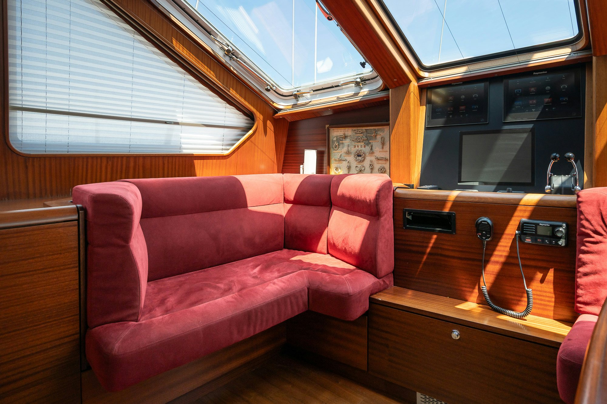 a red couch in a room aboard PLAYMOBIL Yacht for Sale