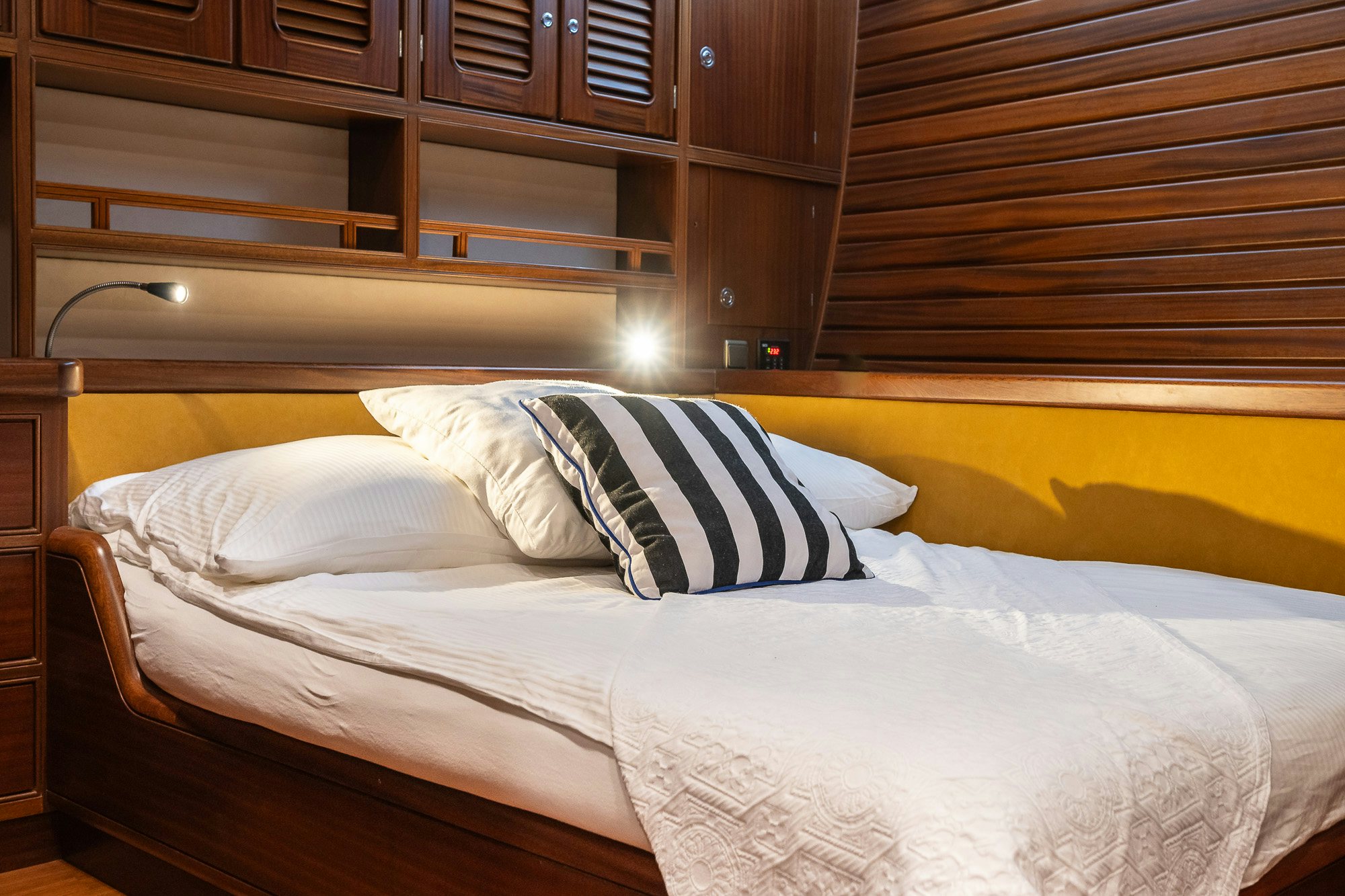 a bed with white sheets aboard PLAYMOBIL Yacht for Sale