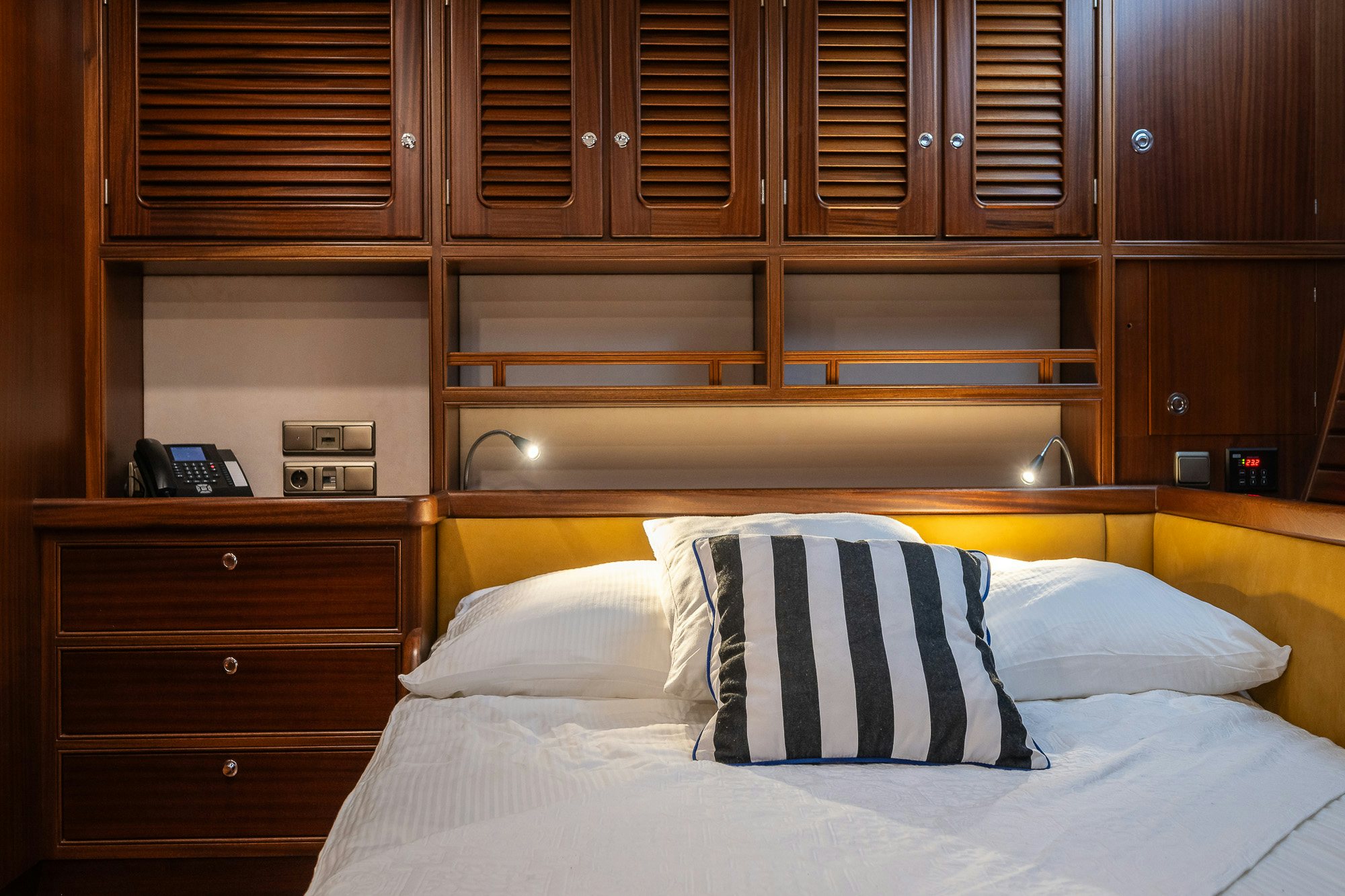 a bed with white sheets and pillows aboard PLAYMOBIL Yacht for Sale