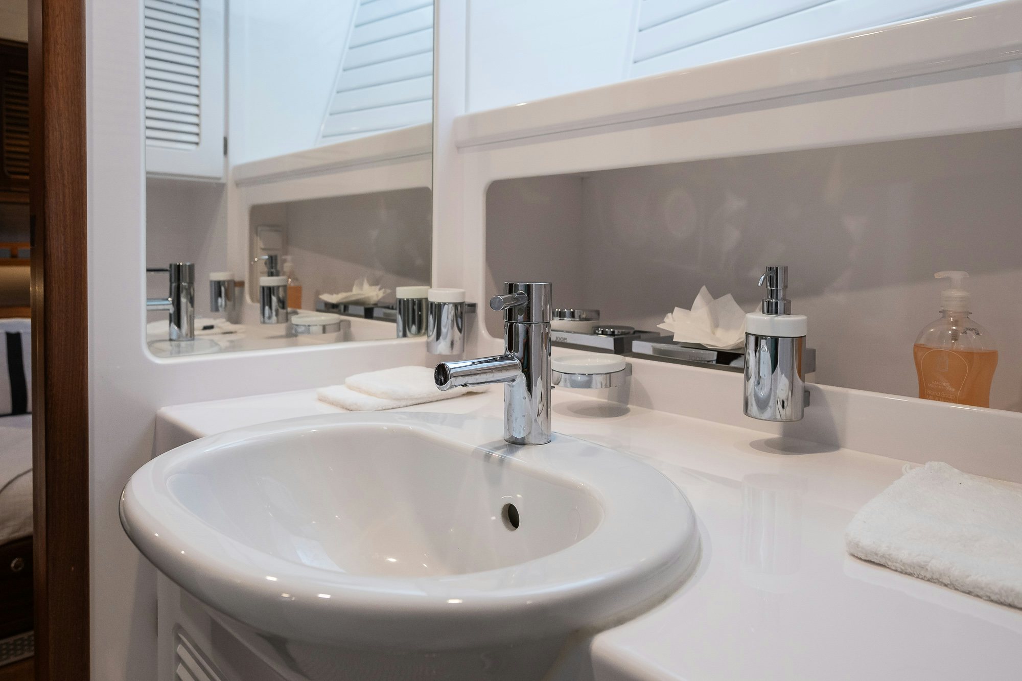 a bathroom sink with a mirror above it aboard PLAYMOBIL Yacht for Sale