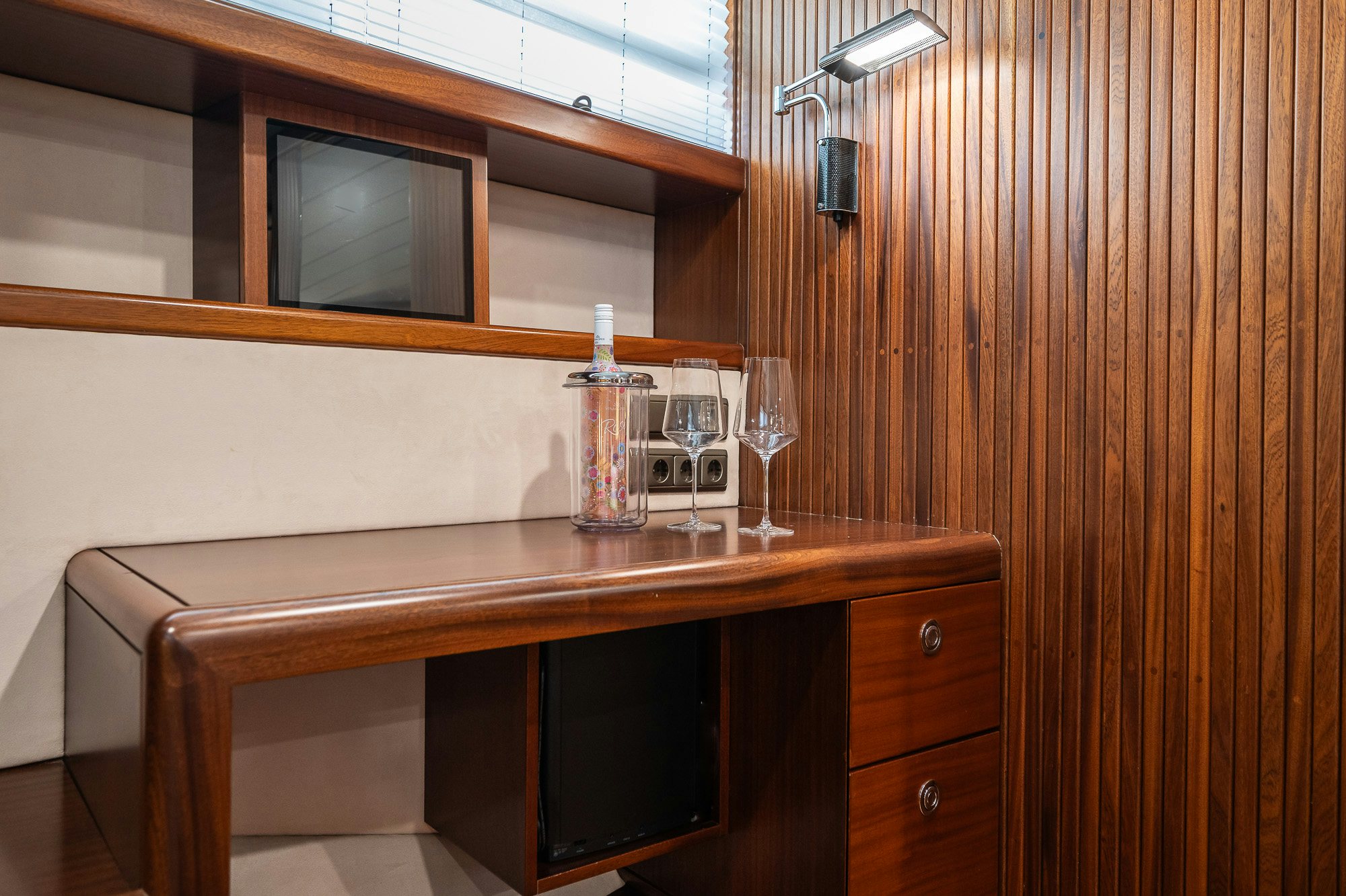 a bottle of wine and a glass on a table aboard PLAYMOBIL Yacht for Sale