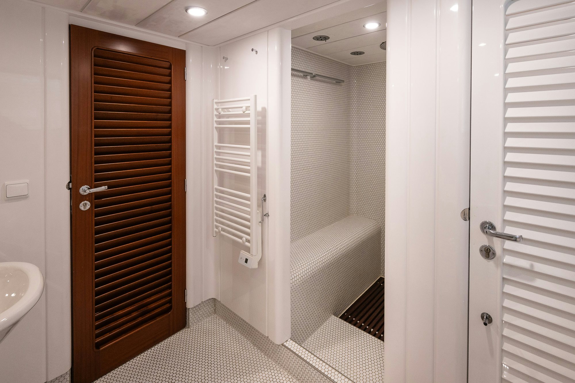 a bathroom with a wood door aboard PLAYMOBIL Yacht for Sale